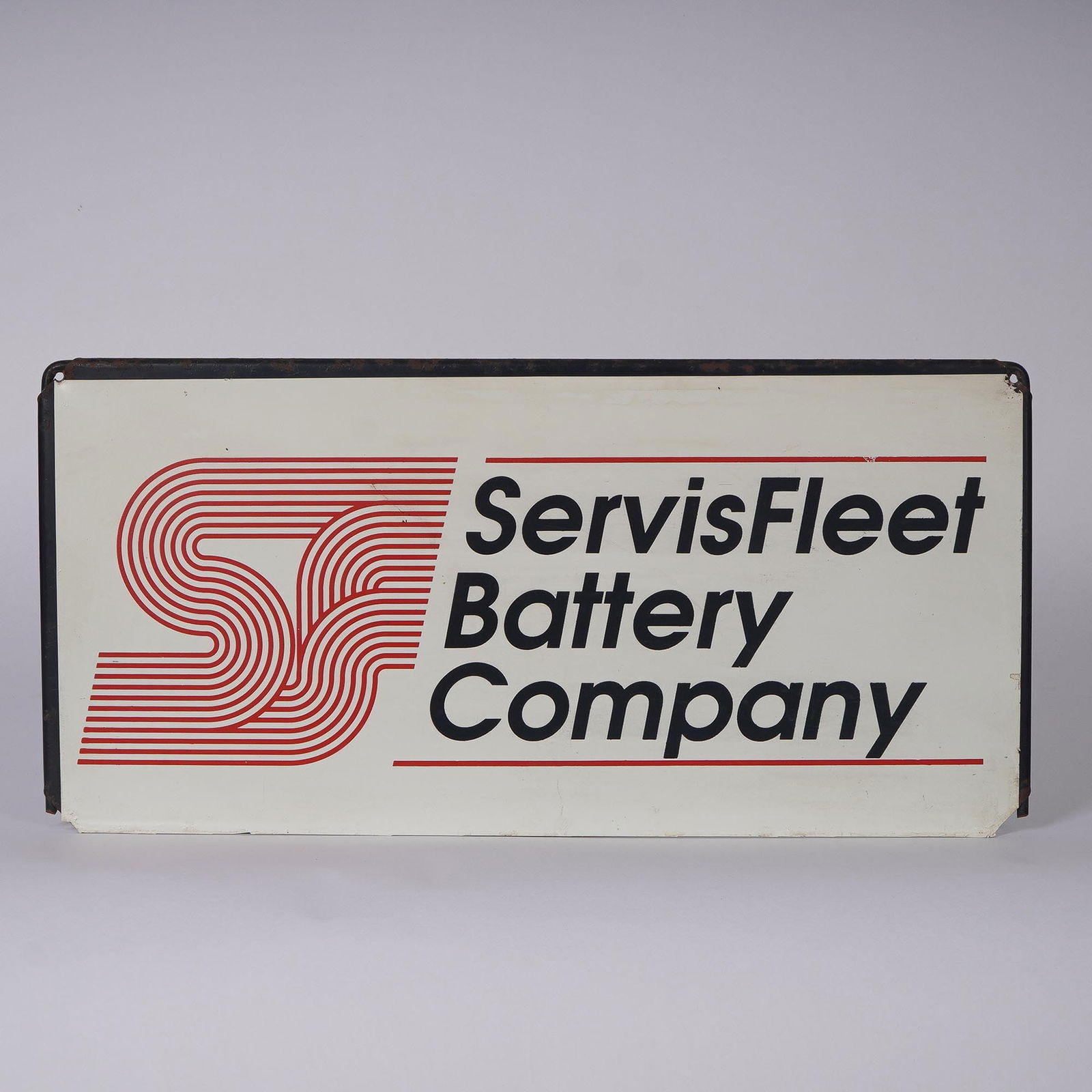 ServisFleet Battery Company Metal Advertising Sign: Vintage metal advertising sign for the ServisFleet Battery Company. The sign features bold red and black graphics with the company?s stylized SF logo and name against a white background. Constructed o