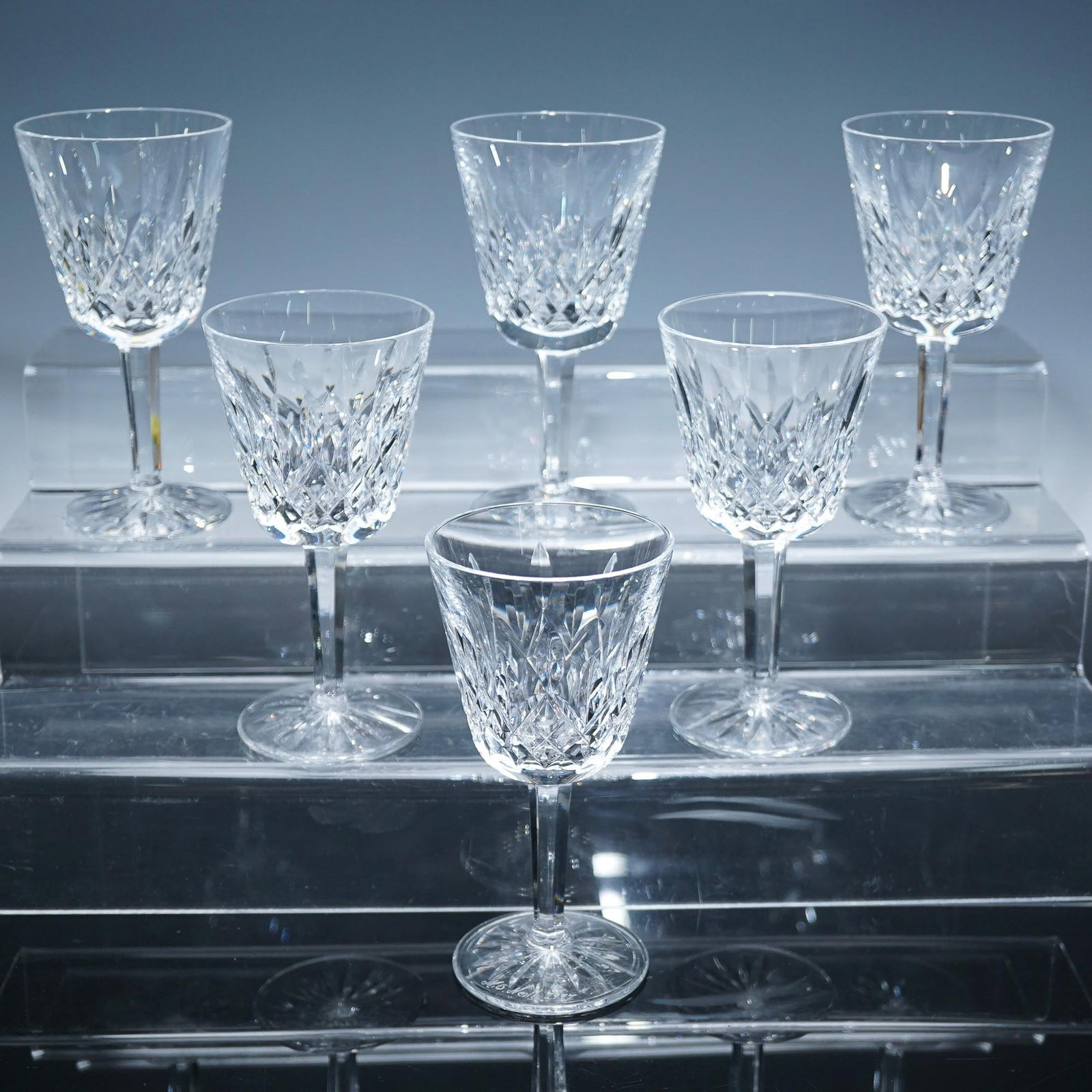 6pc Waterford Crystal Signed Claret Wine Glasses, Lismore: A refined each expertly crafted in the classic diamond-cut pattern showcasing the elegance and clarity. These glasses feature brilliant star-cut bases and elongated stems that enhance their timeless s