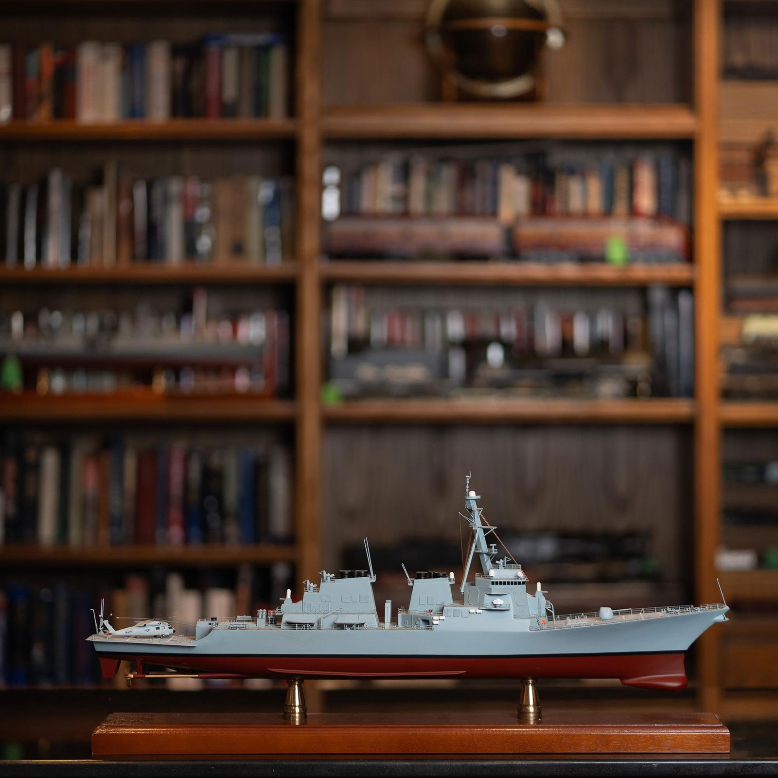 Model of Arleigh Burke-Class Guided Missile Destroyer: This meticulously crafted model represents an Arleigh Burke-class guided-missile destroyer, a symbol of modern naval warfare and technological superiority. These destroyers, first commissioned in 1991
