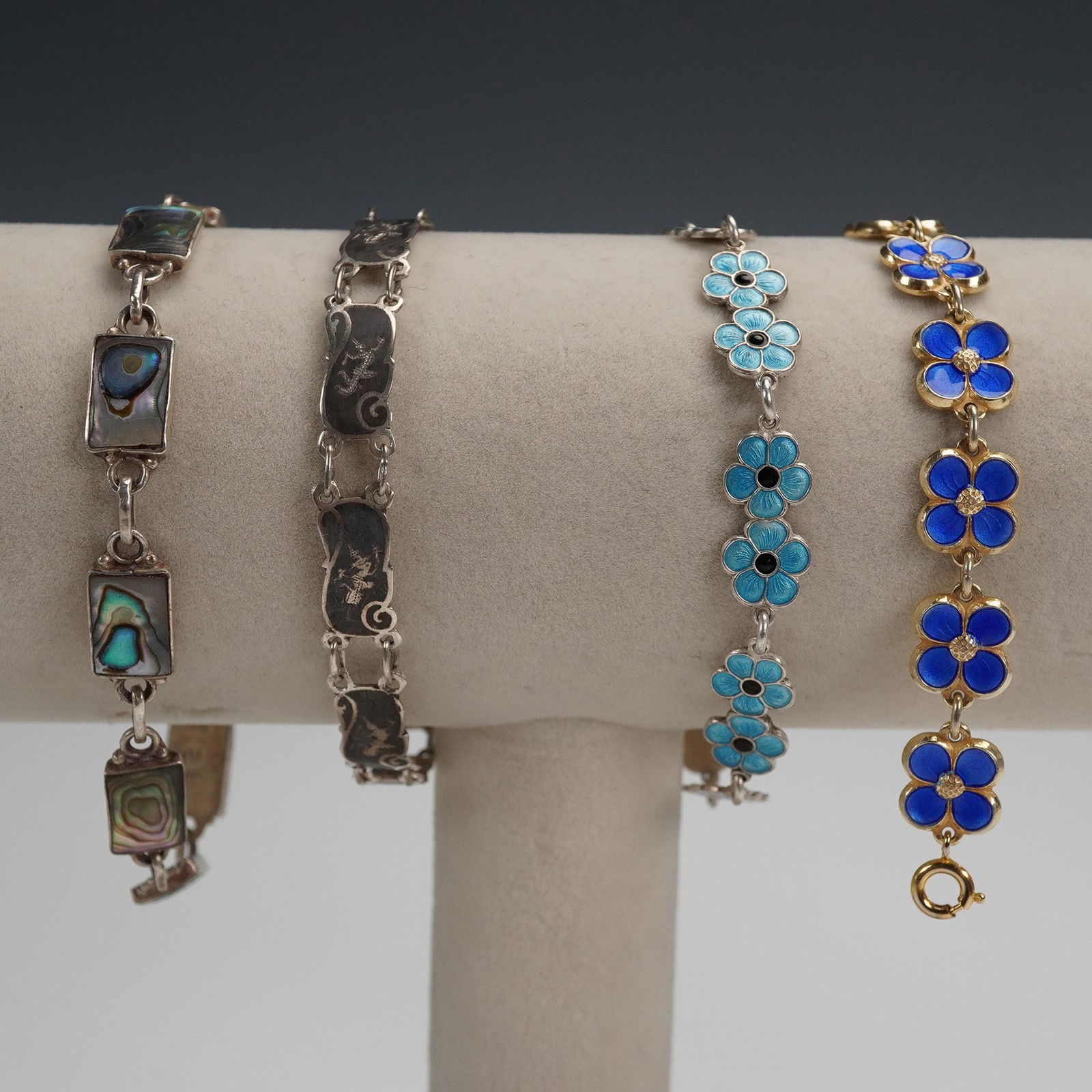 4pc Sterling Silver Link Bracelet Lot, Denmark, Norway, Siam, and Mexico: A vibrant collection of four vintage sterling silver link bracelets, each marked for origin and crafted with distinctive regional artistry. Includes an abalone inlay bracelet marked Made in Mexico 925