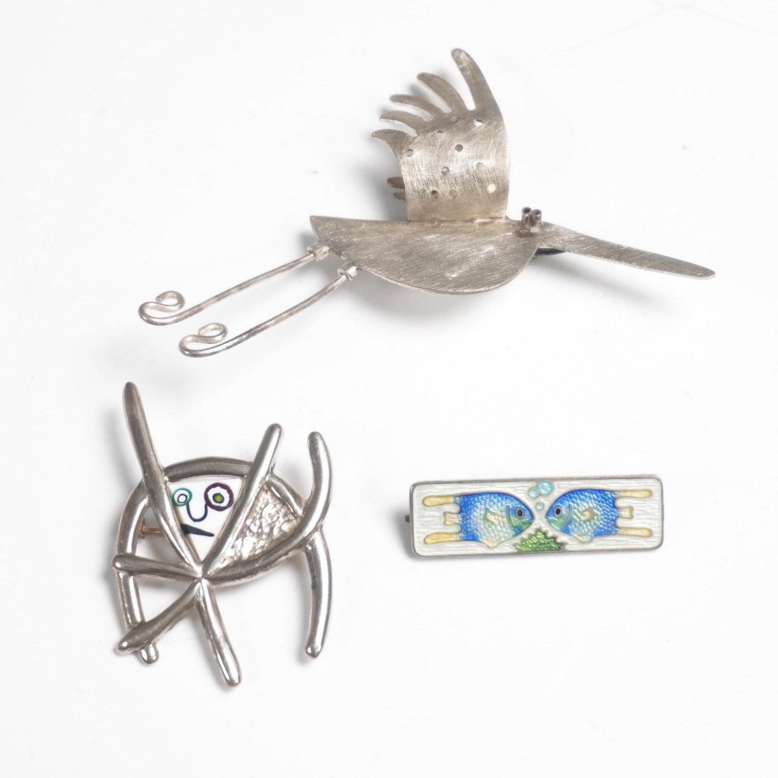 3pc Sterling and Enamel Pins Including Fish Motif and Modernist Designs: Group of three whimsical and artistic pins including: one rectangular enamel pin marked Bermuda Sterling, featuring a charming design of two blue fish facing each other over green seaweed; one abstrac