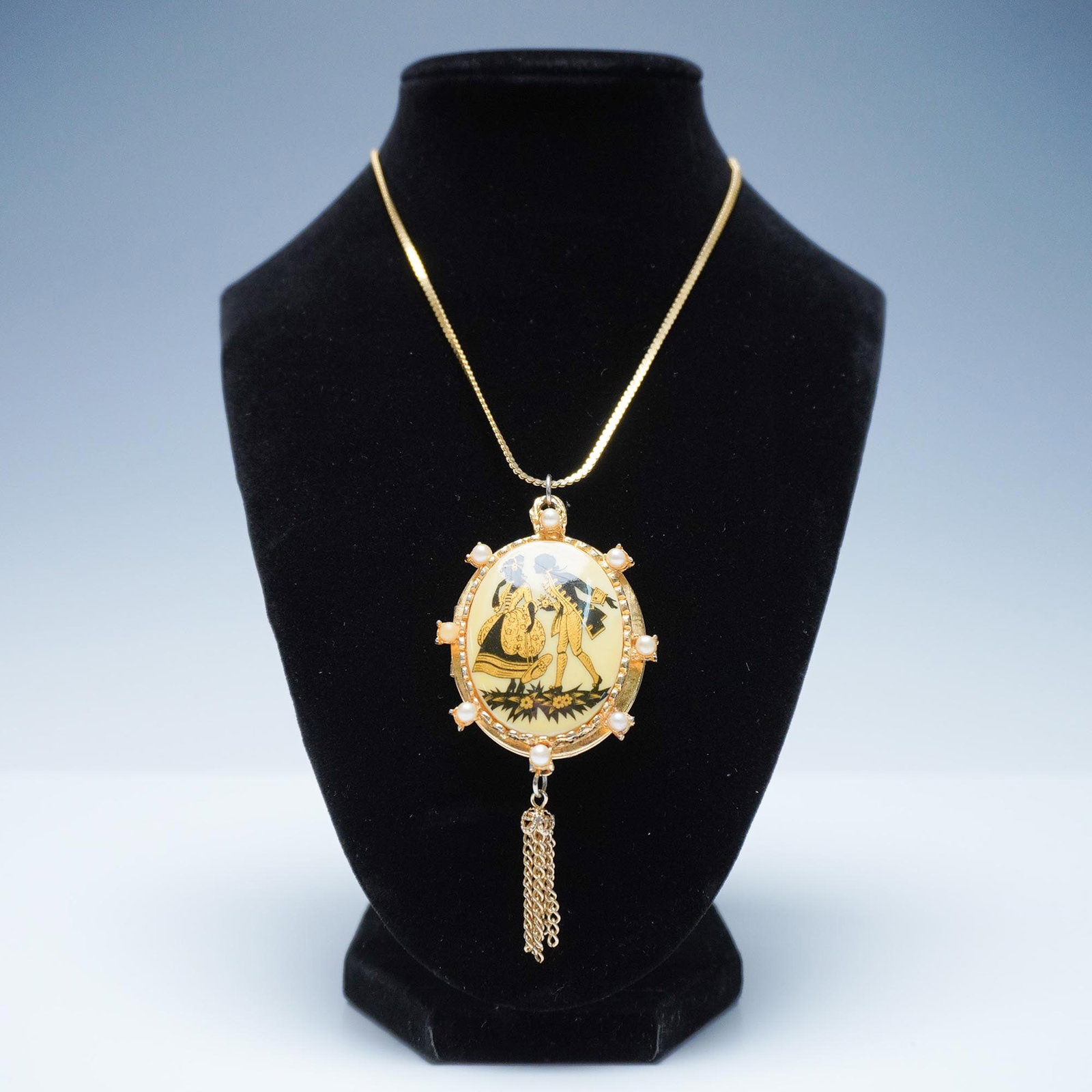 Vintage Victorian Revival Double Locket Necklace with Chain: This vintage locket necklace features an ornate oval locket with faux pearls, suspended from a delicate chain. The locket showcases intricate engraved detailing on its front, adding to its timeless ch