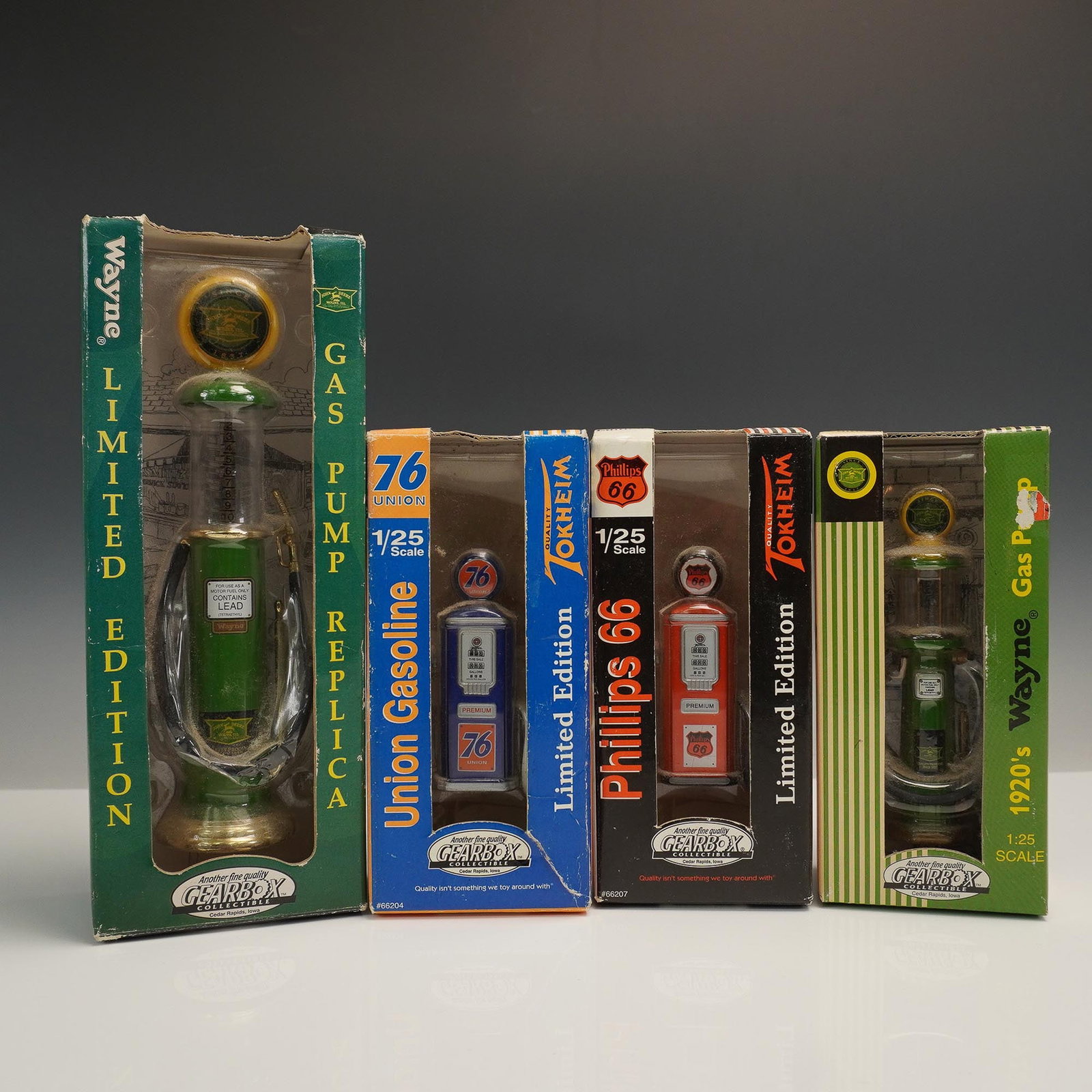 4pc Gearbox Collectible Gas Pump Replica Lot, 1/25 Scale: Four-piece collection of Gearbox collectible die-cast metal gas pump replicas, each in original packaging. This 1/25 scale limited edition set includes branded designs for Union 76, Phillips 66, and t