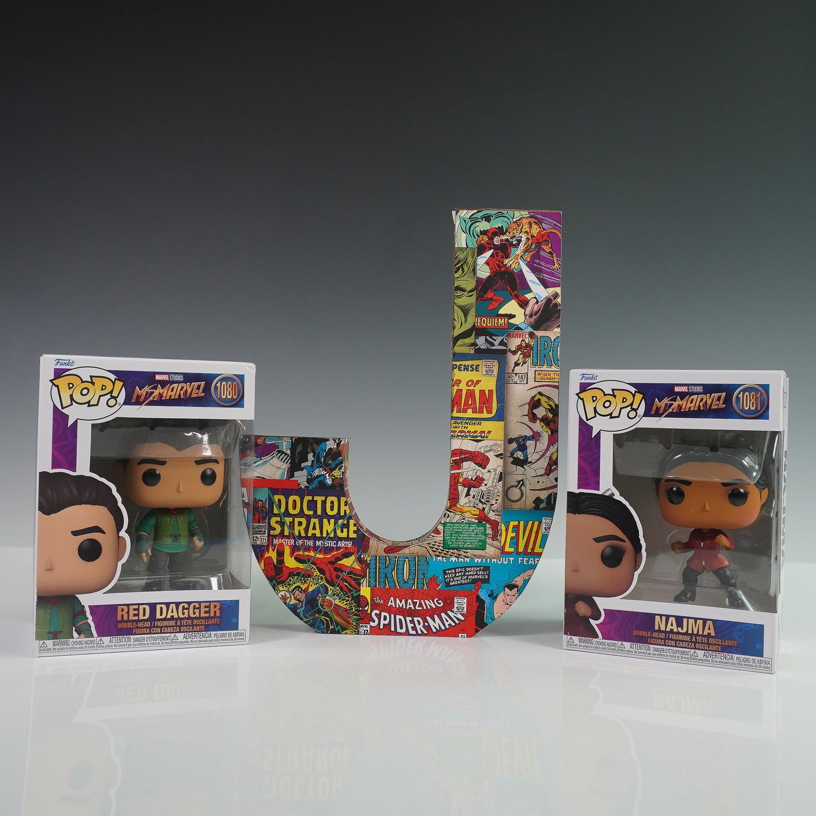 3pc Marvel Collectible Lot, Ms. Marvel Funko Pops and Comic Collage J: A 3-piece Marvel-themed collector's lot featuring: 1) Red Dagger (#1080) and 2) Najma (#1081) boxed Funko Pop! vinyl figures from the Ms. Marvel series, and 3) a large decorative letter "J" covered in