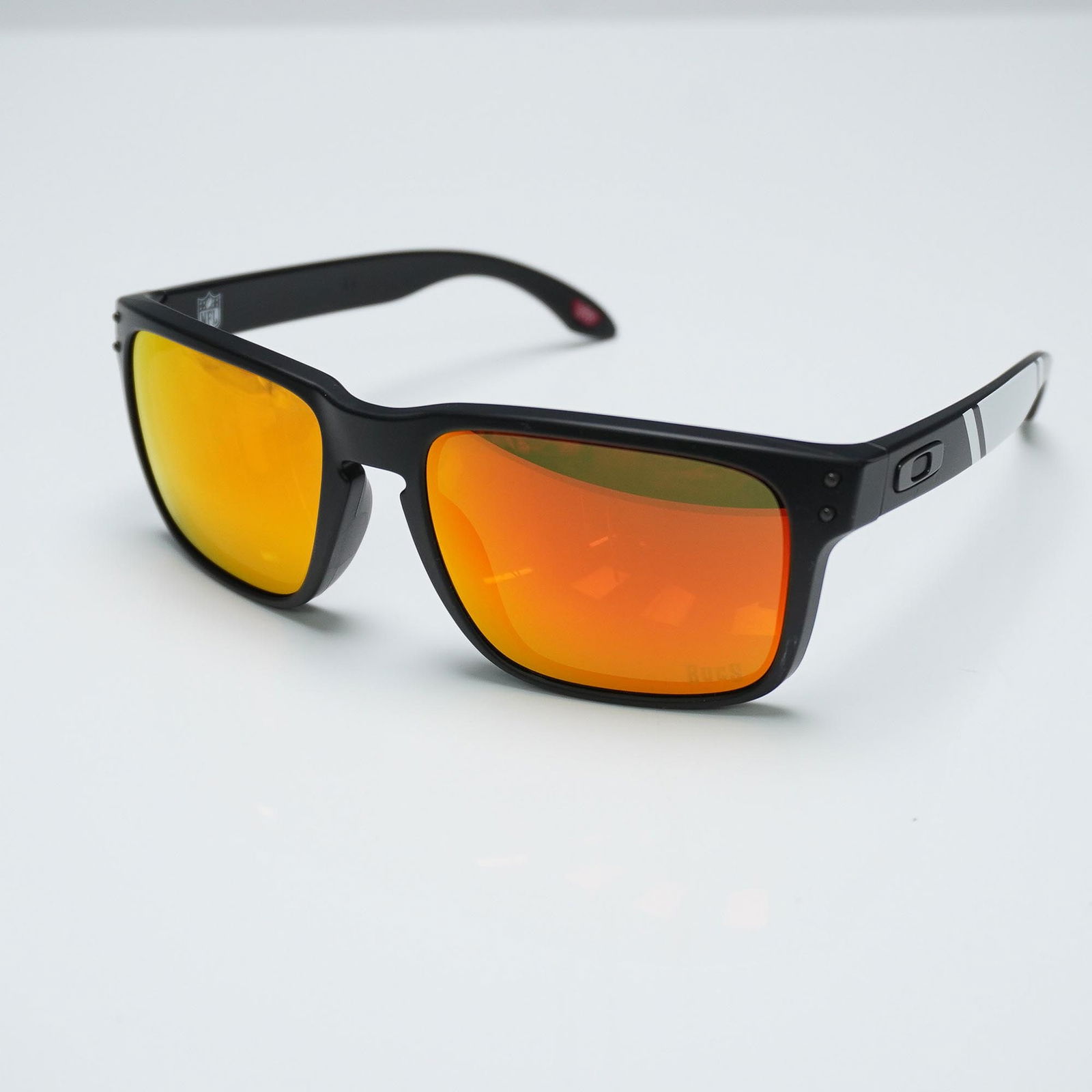 Oakley Holbrook Sunglasses, NFL Bucs Edition OO9102-T155: Oakley Holbrook sunglasses, NFL limited edition featuring Tampa Bay Buccaneers-themed arms with BUCS lettering and silver stripe accents. This model, OO9102-T155, includes a matte black frame and mirr