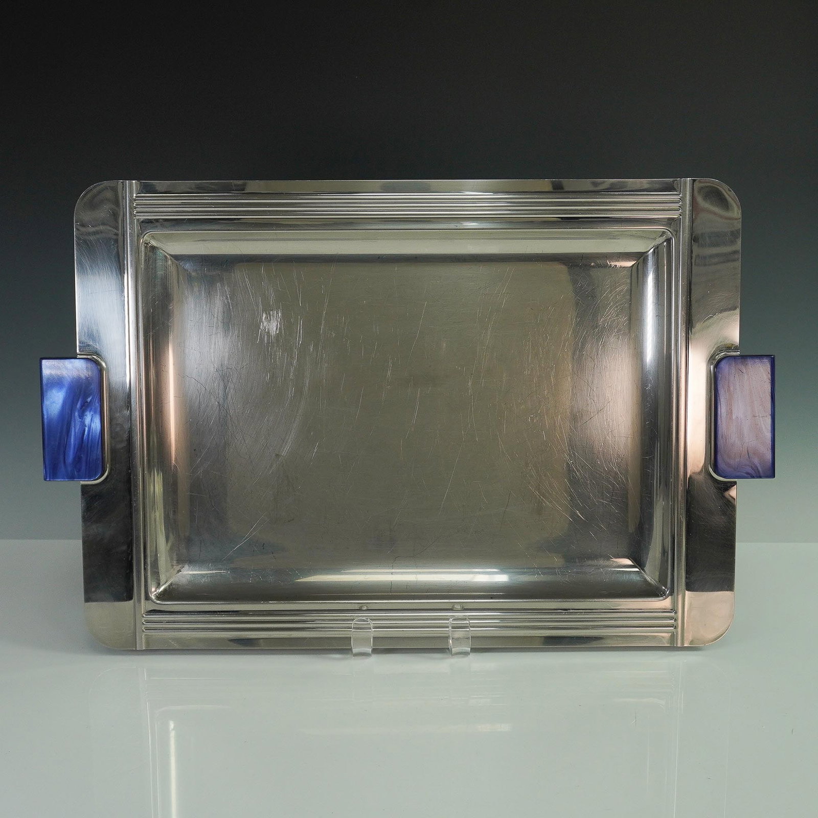 Jean Couzon Stainless Steel Tray with Blue Marbled Handles: Modernist Jean Couzon stainless steel serving tray featuring a sleek rectangular form with fluted Art Deco-style edge detailing. The tray is accented with striking marbled blue plastic side handles th