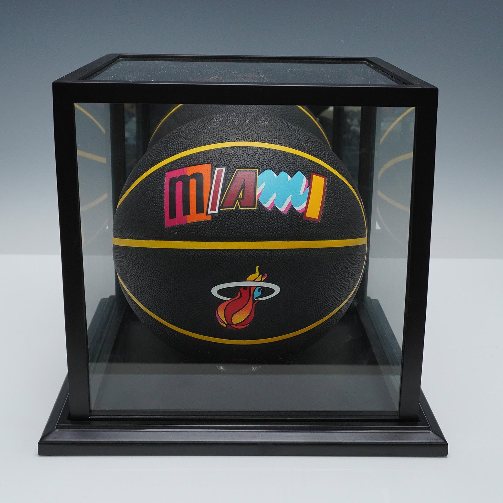 Miami Heat City Edition 75th Anniversary Basketball: Official Wilson NBA basketball commemorating the league's 75th anniversary, designed in the Miami Heat's city edition style. This black size 7 basketball features multicolor typography and the Heat's 