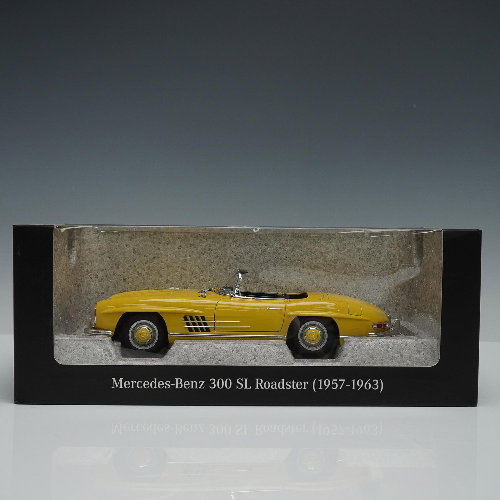 Mercedes-Benz 300 SL Roadster 1:18 Scale Model, Sun Yellow: 1:18 scale die-cast model of the Mercedes-Benz 300 SL Roadster (1957?1963) in sun yellow. Features detailed interior and chrome accents. Includes original display box. Issued: 21st century Dimensions: