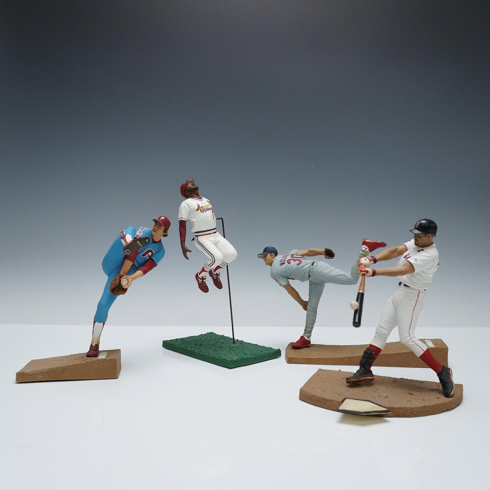 4pc McFarlane MLB Action Figurines, Ortiz, Carlton, Smith, Wainwright: A group of Major League Baseball action figures featuring legendary and modern era players in dynamic poses. Includes Steve Carlton #32 Philadelphia Phillies, Ozzie Smith #1, St. Louis Cardinals, Adam