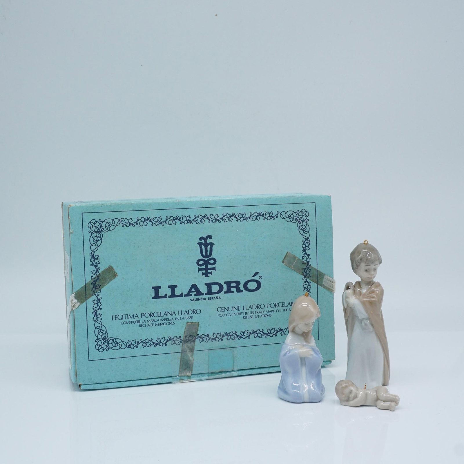 Lladro Porcelain Figurine, Mini Holy Family 1005657: This Lladro porcelain figurine, titled "Mini Holy Family" (Spanish name: Mini Sagrada Familia), was sculpted by Francisco Polope and issued in 1989. This beautifully crafted piece captures the serene 