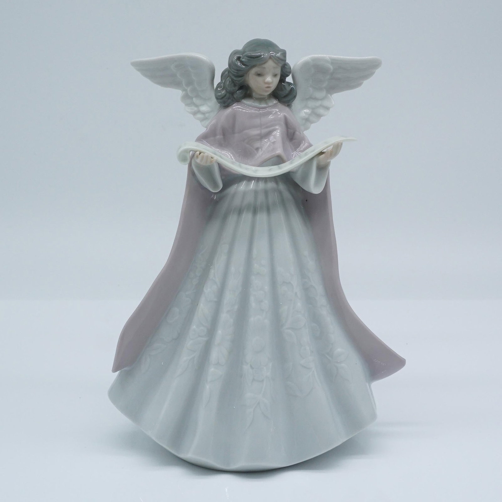 Lladro Porcelain Figurine, Tree Topper '91 (Pink) 1005831: Lladro porcelain figurine titled Tree Topper '91 (Pink), item number 1005831, features a graceful angel figure with flowing wings and a serene expression, holding a delicate scroll. Sculpted by Franci
