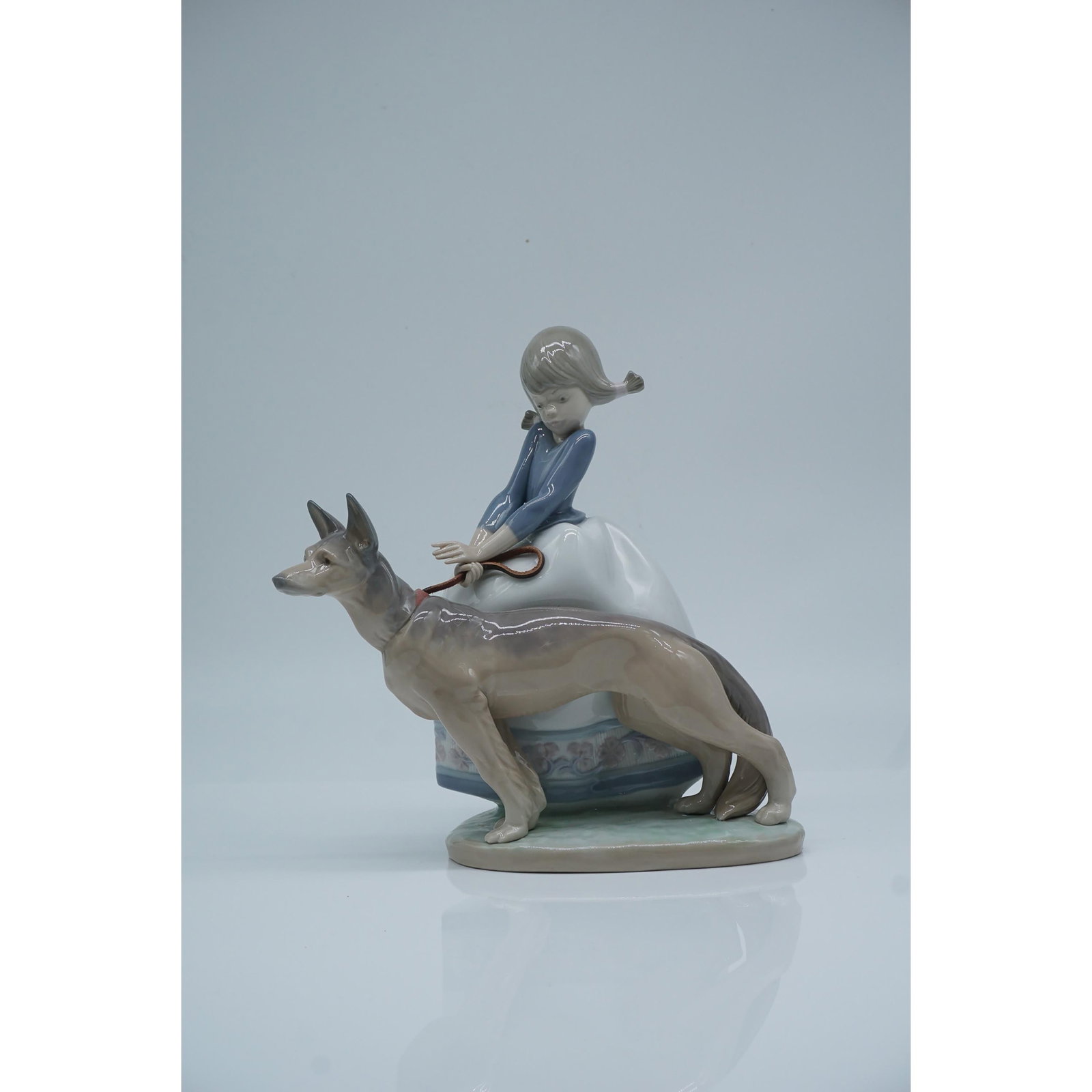 Lladro Porcelain Figurine, Not So Fast 01001533: Lladro porcelain figurine #01001533, Not So Fast, capturing a playful moment as a young girl attempts to keep pace with her spirited dog. The piece reflects Lladro?s mastery in portraying dynamic move