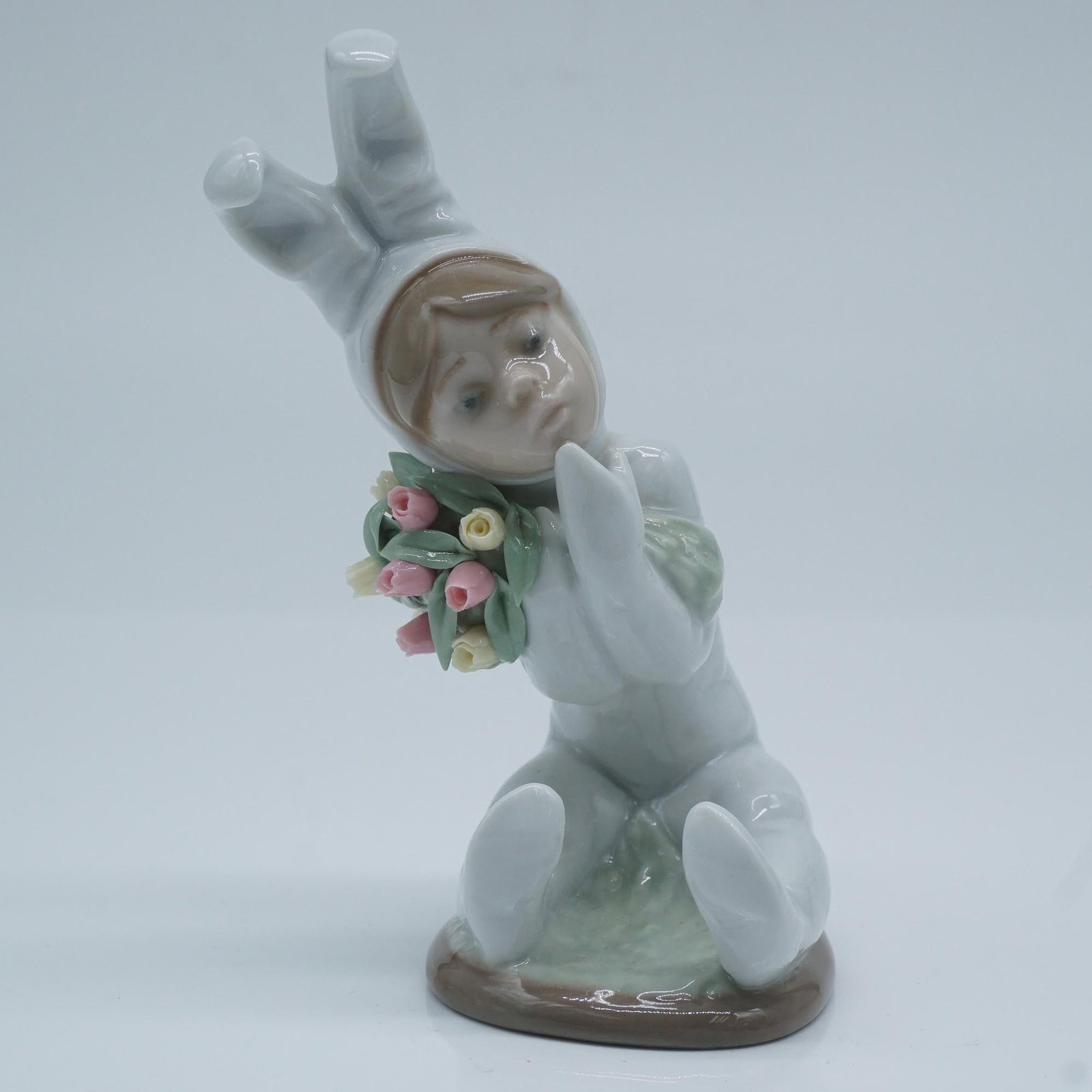 Lladro Porcelain Figurine, Spring Flowers 1001509: This Lladro porcelain figurine, model number 1509, titled "Spring Flowers" (Spanish name: Ni?o Conejito Con Tulipanes), was sculpted by Juan Huerta. It was first issued in 1986 and retired in 1991. Th