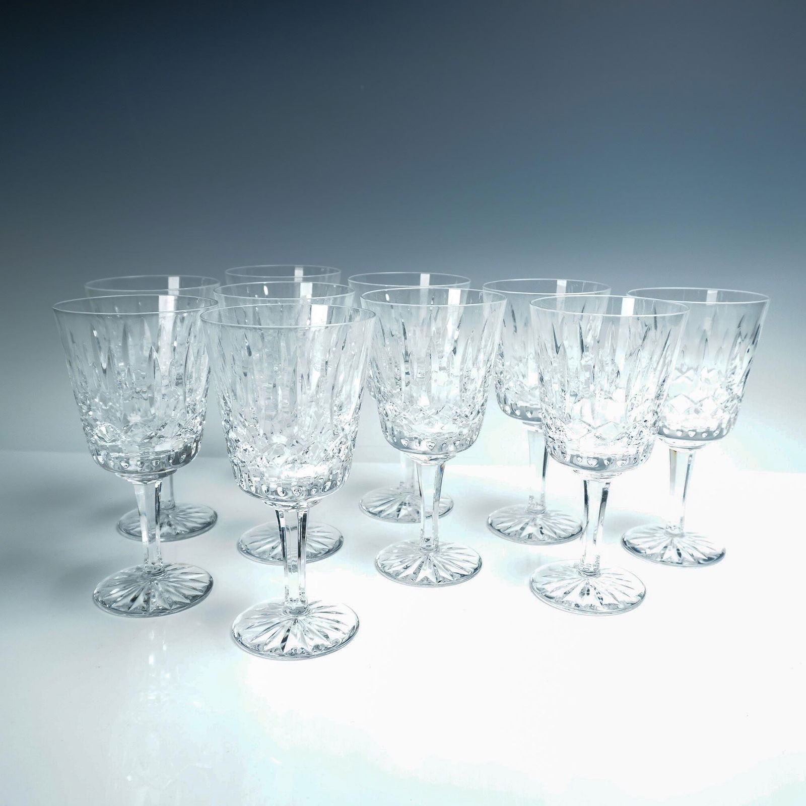 10pc Cut Crystal Water Goblets with Starburst Bases: This elegant 10 piece set of cut crystal water goblets features a faceted bowl with vertical cuts and a beautifully detailed starburst pattern on each base. The glasses exhibit fine craftsmanship with