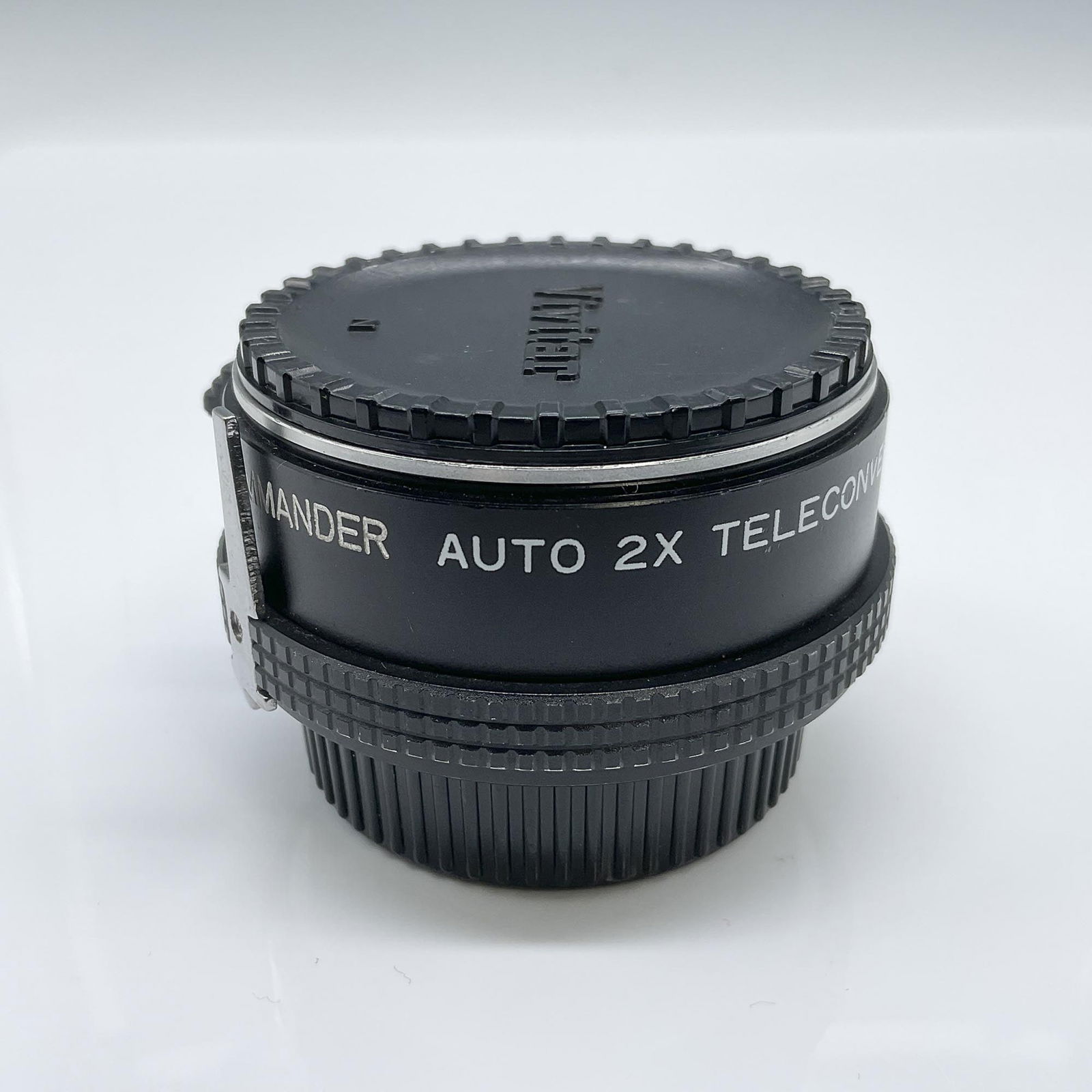 Vivitar 2pc Auto 2X Teleconverter with Caps: Vivitar Auto 2X Teleconverter (Model NF) designed to enhance the focal length of compatible camera lenses. This high-quality teleconverter measures 1.75"H when extended and includes two protective cap