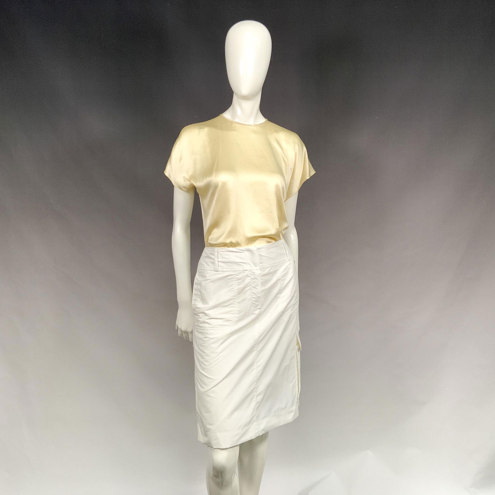 Escada Sport White Cotton Skirt: A sporty white A-line skirt with a sleek, cargo-inspired design. Featuring a button and zip-front closure, practical side pockets, and a full lining, it is both stylish and functional. Finished with t