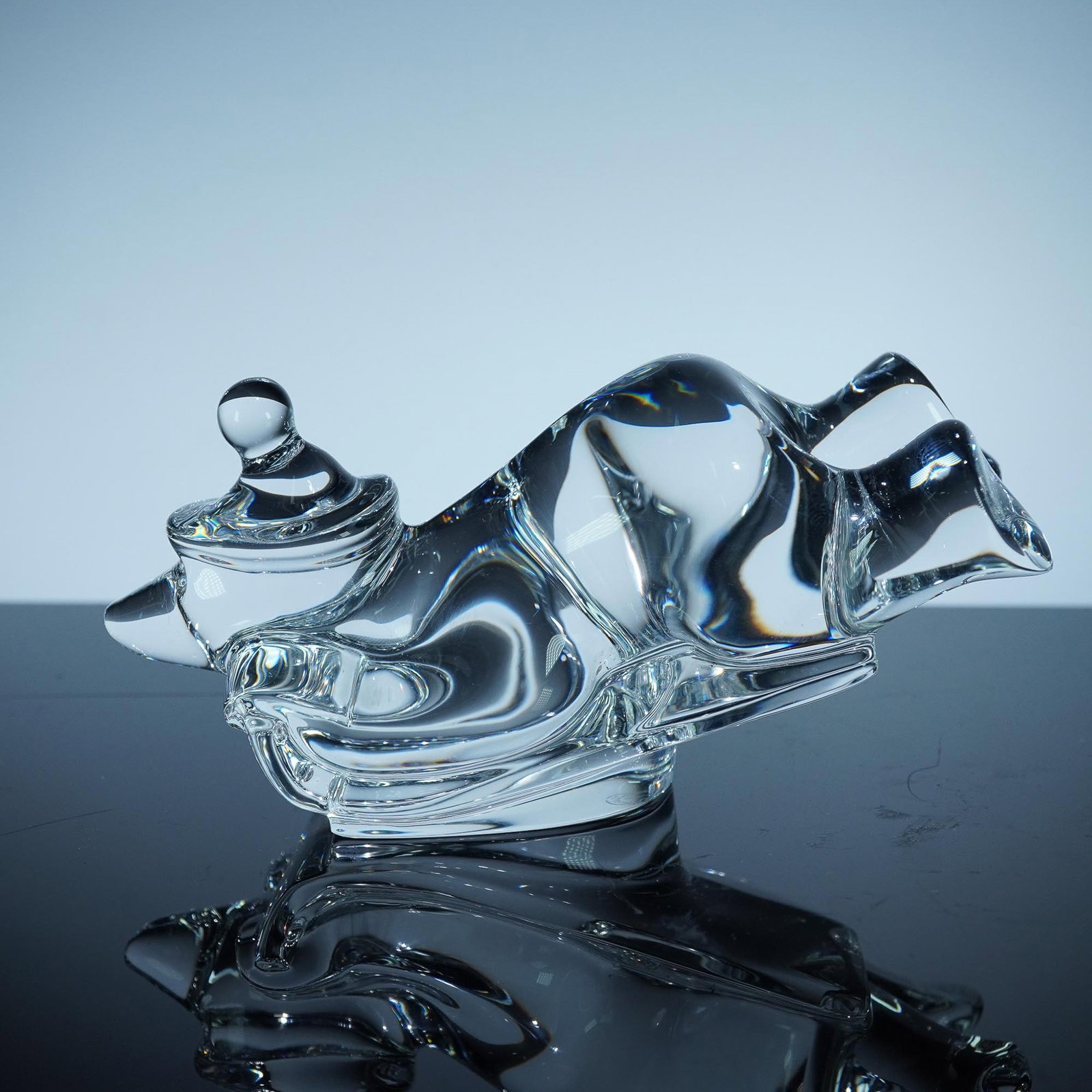 Baccarat Crystal Figurine, Sledding Bear: This charming Baccarat crystal figurine captures the joyful motion of a bear riding a sled, elegantly crafted in clear crystal. With its whimsical design and dynamic posture, the bear leans back in de