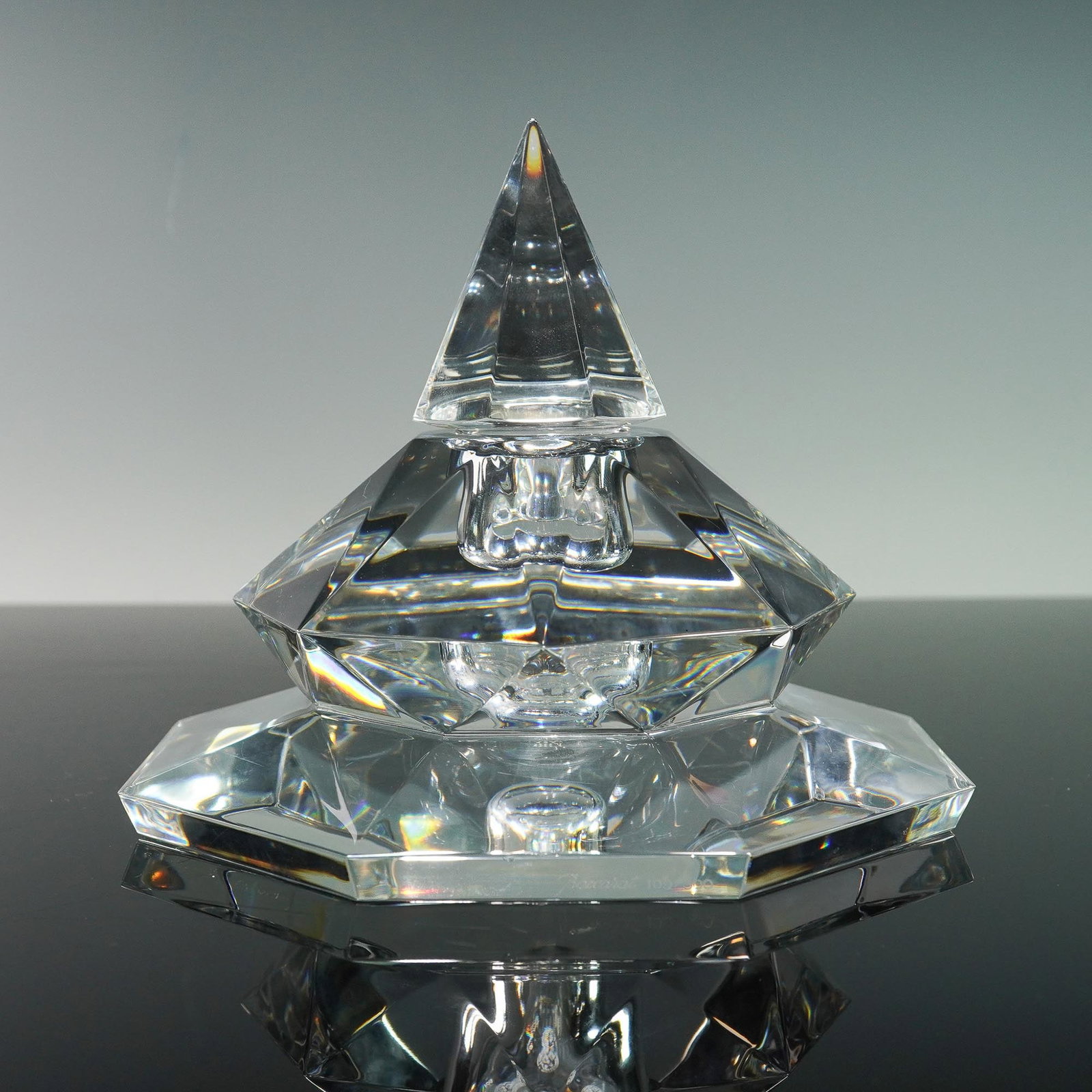 Baccarat Limited Edition Faceted Crystal Inkwell or Scent Bottle: Limited edition Baccarat crystal inkwell or scent bottle featuring a striking geometric form with a tall, faceted pyramid stopper, a removable interior reservoir insert, and a broad, octagonal base. T