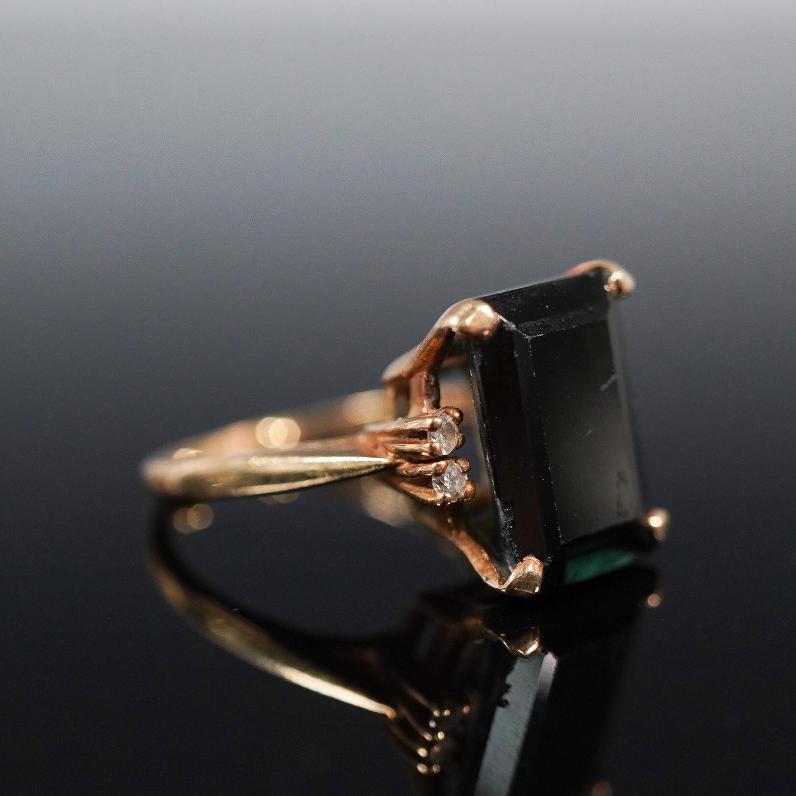 14K Gold Rectangular Cut Dark Stone Statement Ring: Vintage 14K gold ring featuring a striking rectangular step-cut dark stone, set in a bold four-prong mount with an openwork gallery and classic split shoulders. The deep color of the center stone give