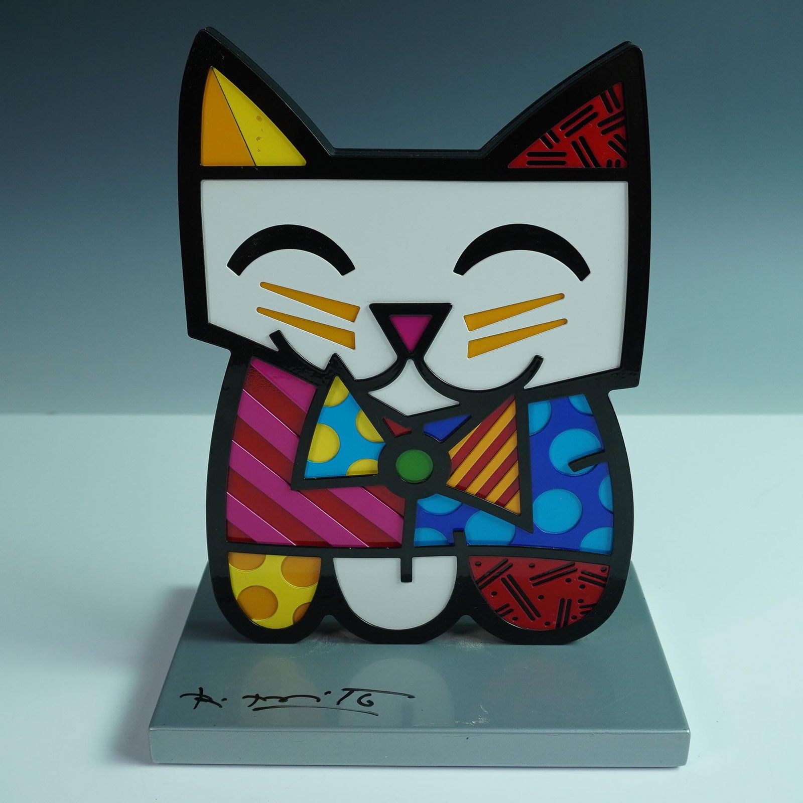 Romero Britto "Squeaki" Silver Base Sculpture: Squeaki is a charming and colorful sculpture by Romero Britto, capturing a whimsical cat in his distinct pop art style. The sculpture is vibrant with patterns and bright colors that fill every segment