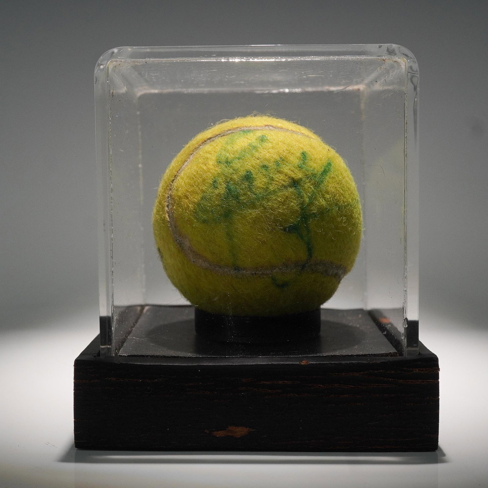 Chris Everet Game Played Signed Tennis Ball: Official game-played tennis ball signed by legendary tennis champion Chris Evert. The ball shows authentic play wear and features a clear, legible signature. Included with the ball is a plastic protec