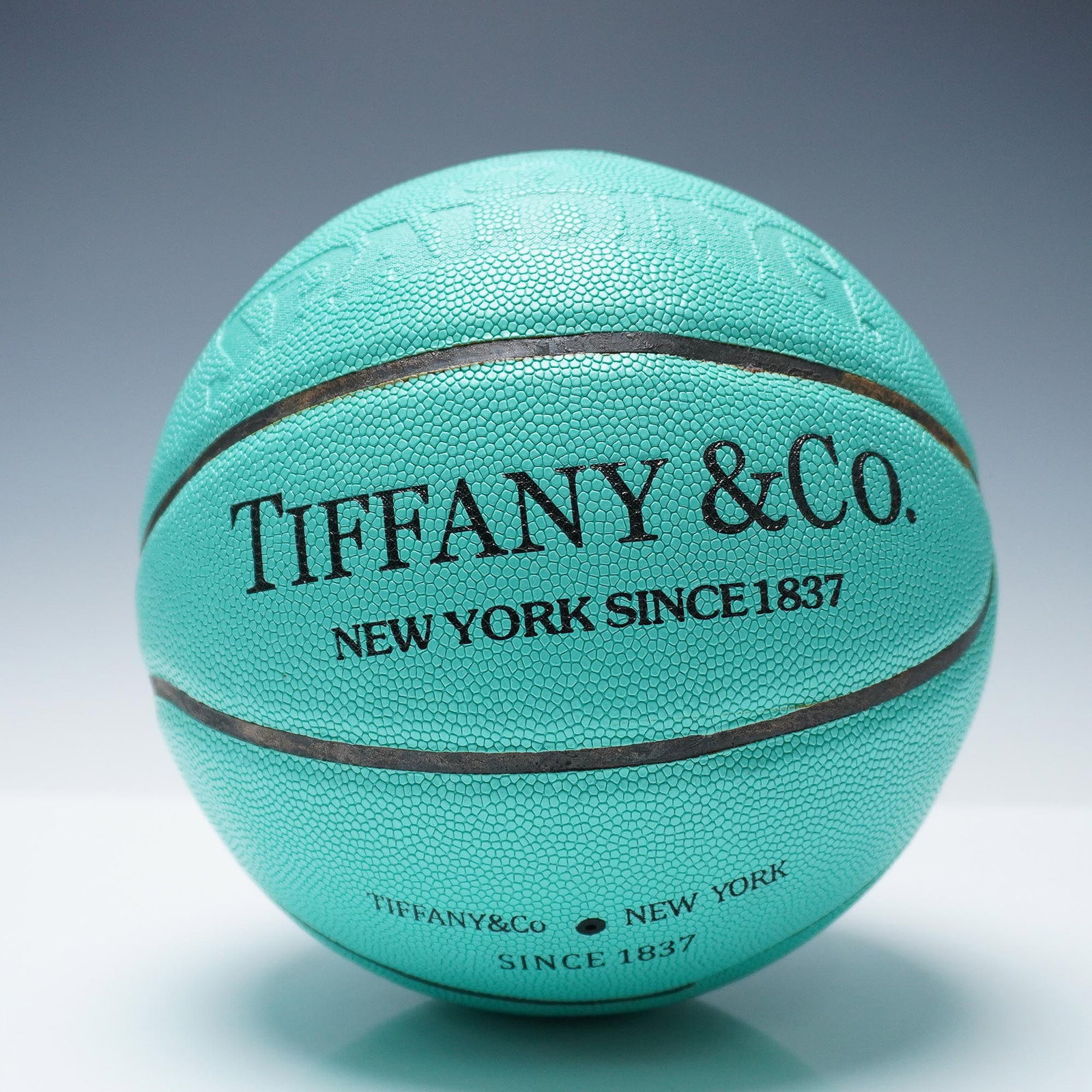 Tiffany & Co. x Spalding Basketball: Tiffany & Co. collaboration with Spalding, featuring the brand's signature turquoise color. The ball is embossed with Tiffany & Co. New York Since 1837, highlighting the company's long-standing legacy