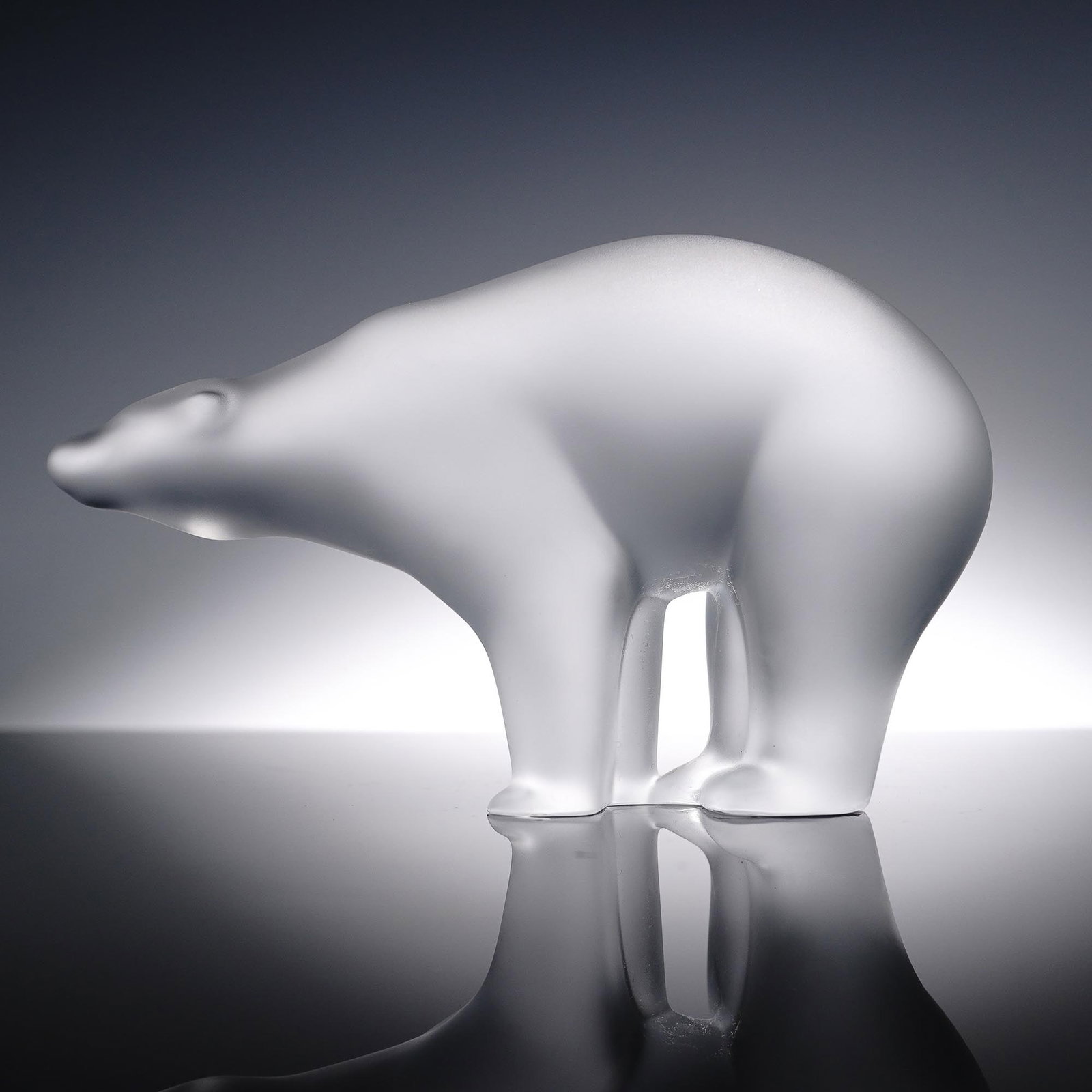 Baccarat Clear Crystal Figurine, Polar Bear: A striking Baccarat clear crystal figurine depicting a polar bear, crafted with a smooth, frosted finish that captures the majestic strength and graceful presence of this arctic giant. The sleek form 
