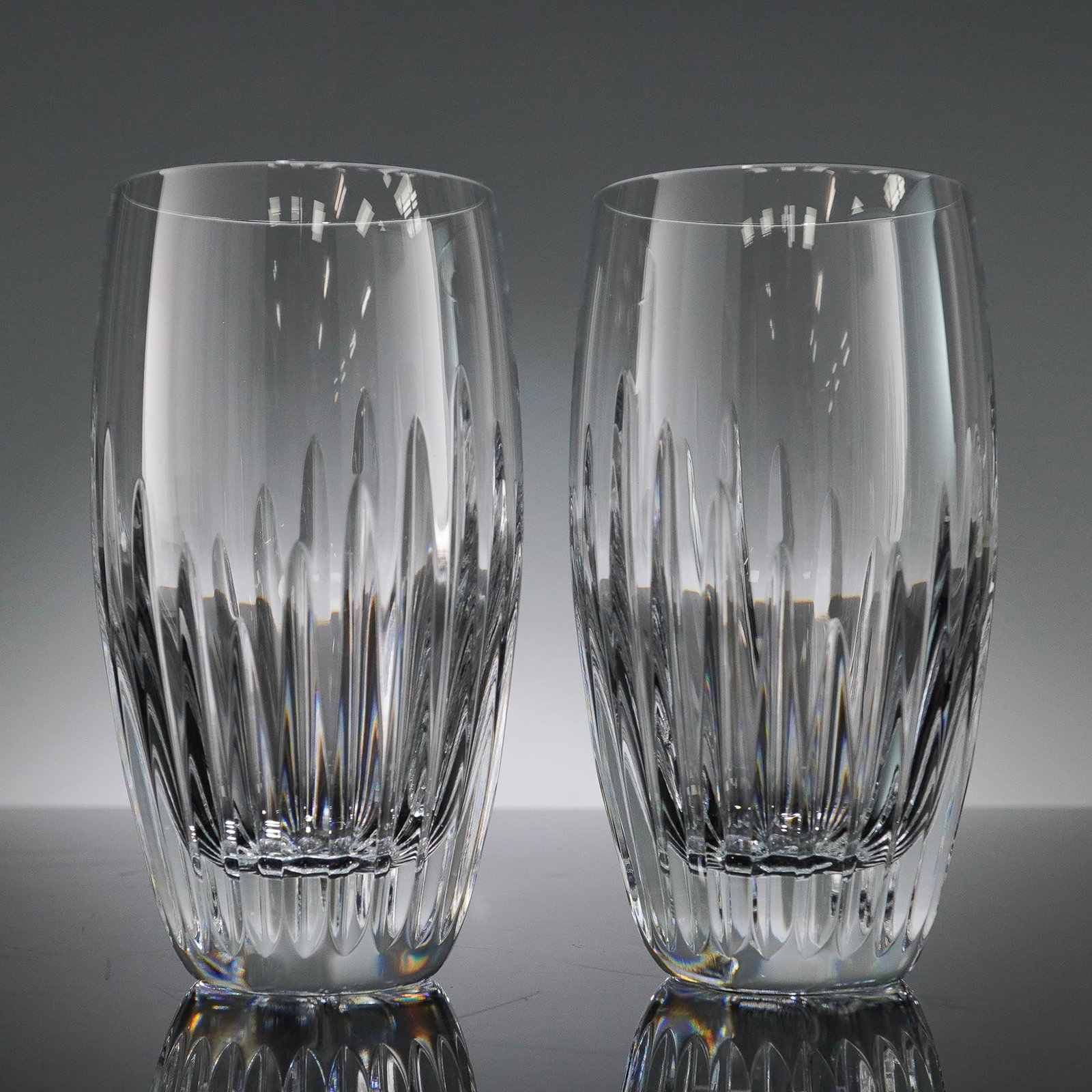 2pc Baccarat Massena Crystal Highball Glasses: Pair of Baccarat crystal highball glasses from the Massena collection. Expertly crafted in France from full lead crystal, each glass features a stunning array of deep vertical cuts that alternate in h