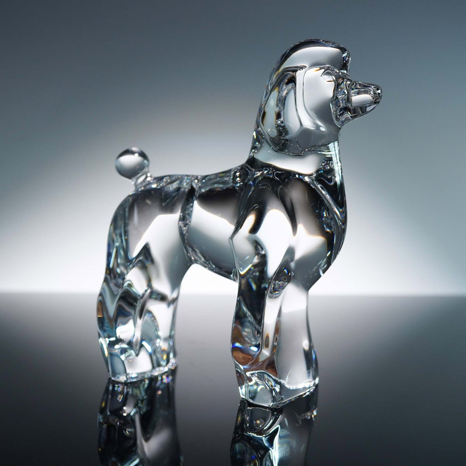 Baccarat Clear Crystal Figurine, Poodle Dog: Elegant Baccarat clear crystal figurine depicting a poodle, expertly crafted with intricate detailing to capture the graceful stance and distinctive silhouette of the breed. Signed with the Baccarat F