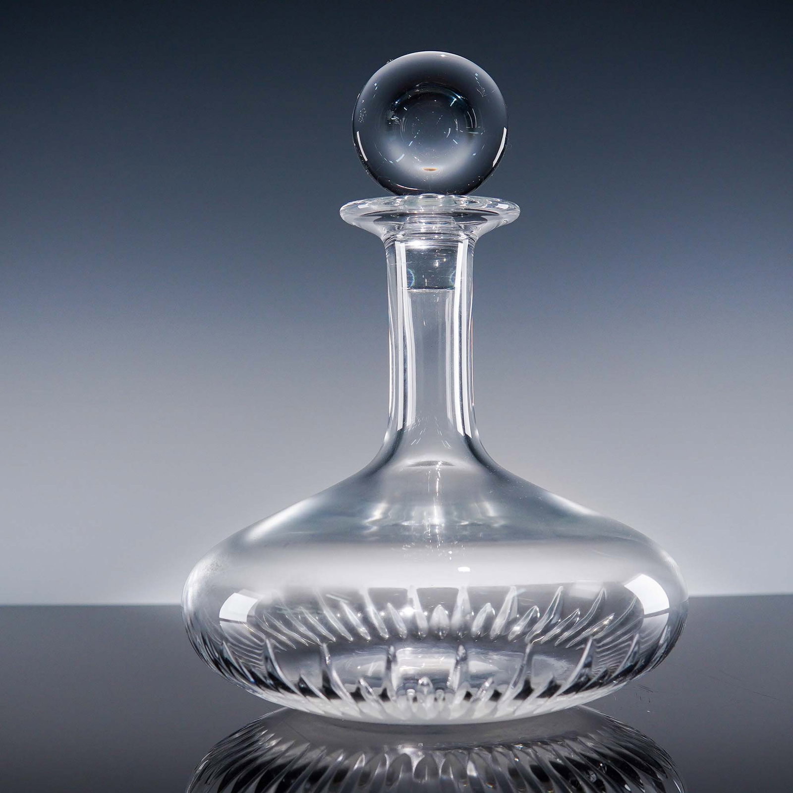 Baccarat Crystal Wine Decanter with Stopper: Refined Baccarat crystal wine decanter featuring a sleek, broad-based silhouette with deep vertical cuts and a tall, tapered neck. Topped with a clear spherical stopper, this decanter showcases Baccar