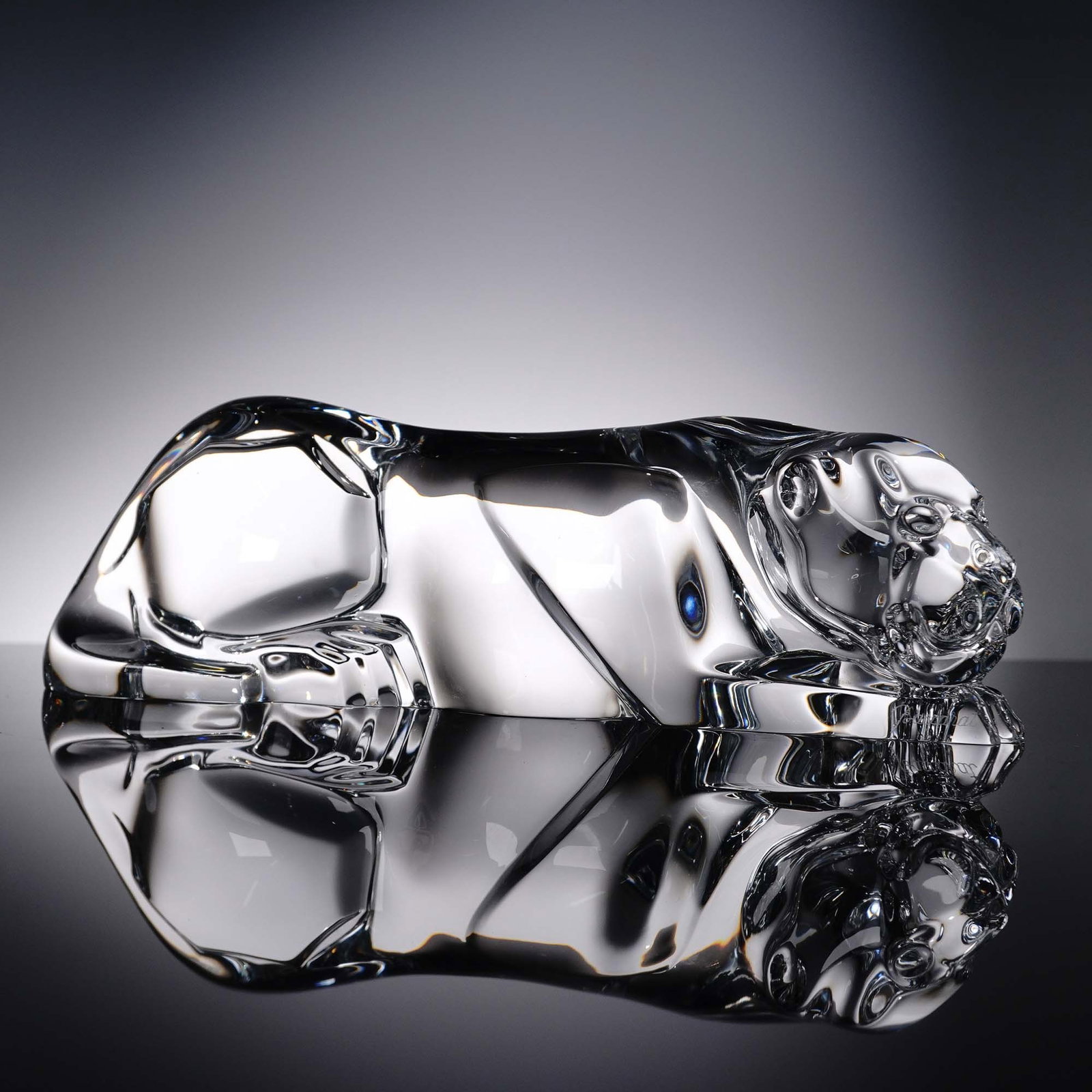 Baccarat Crystal Panther Sculpture: Clear crystal sculpture by Baccarat France, portraying a reclining panther in a sleek, modernist form. This finely rendered piece captures the feline's graceful tension and fluid anatomy through the b
