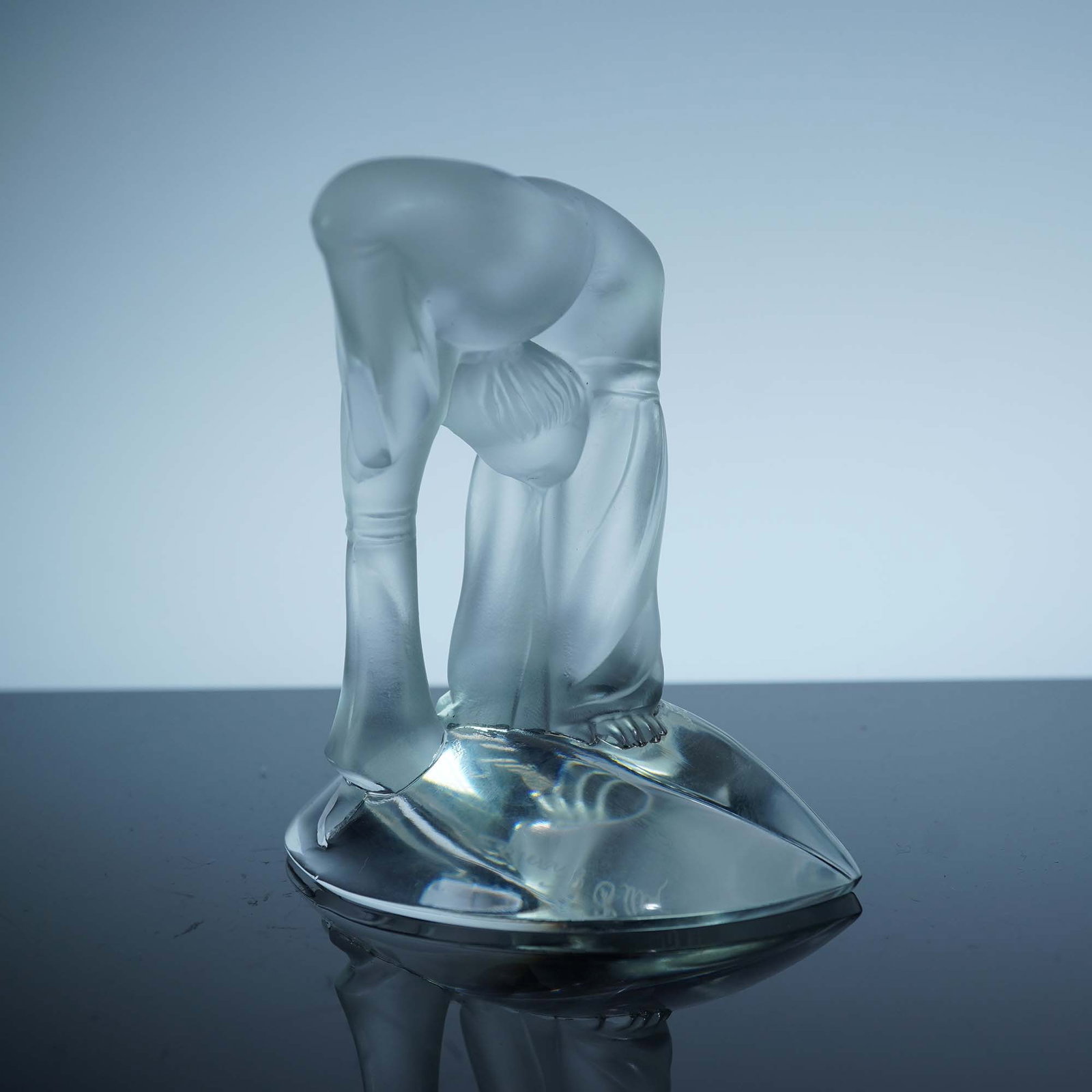 Lalique Crystal Figurine, Gymnast in Backbend: This Lalique frosted crystal figurine depicts a gymnast in a deep backbend, hands reaching toward the base with fluid elegance. The figure's curved posture and flowing garment capture movement and gra