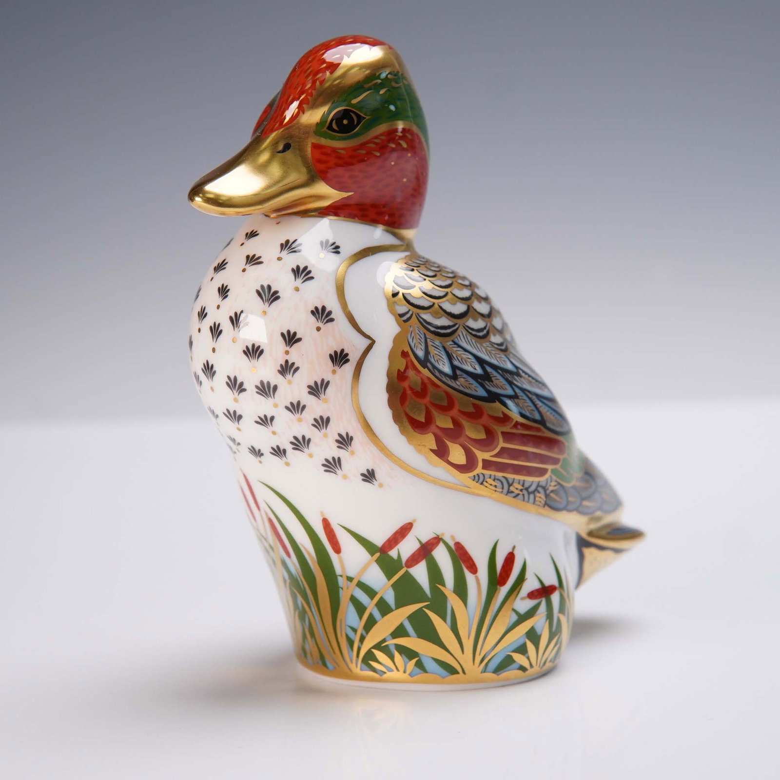 Royal Crown Derby Porcelain Paperweight, Green-Winged Teal: This Royal Crown Derby porcelain paperweight portrays the Green-Winged Teal in vibrant hand-painted colors with 22-karat gold accents highlighting its plumage and intricate detailing. Issued as an exc