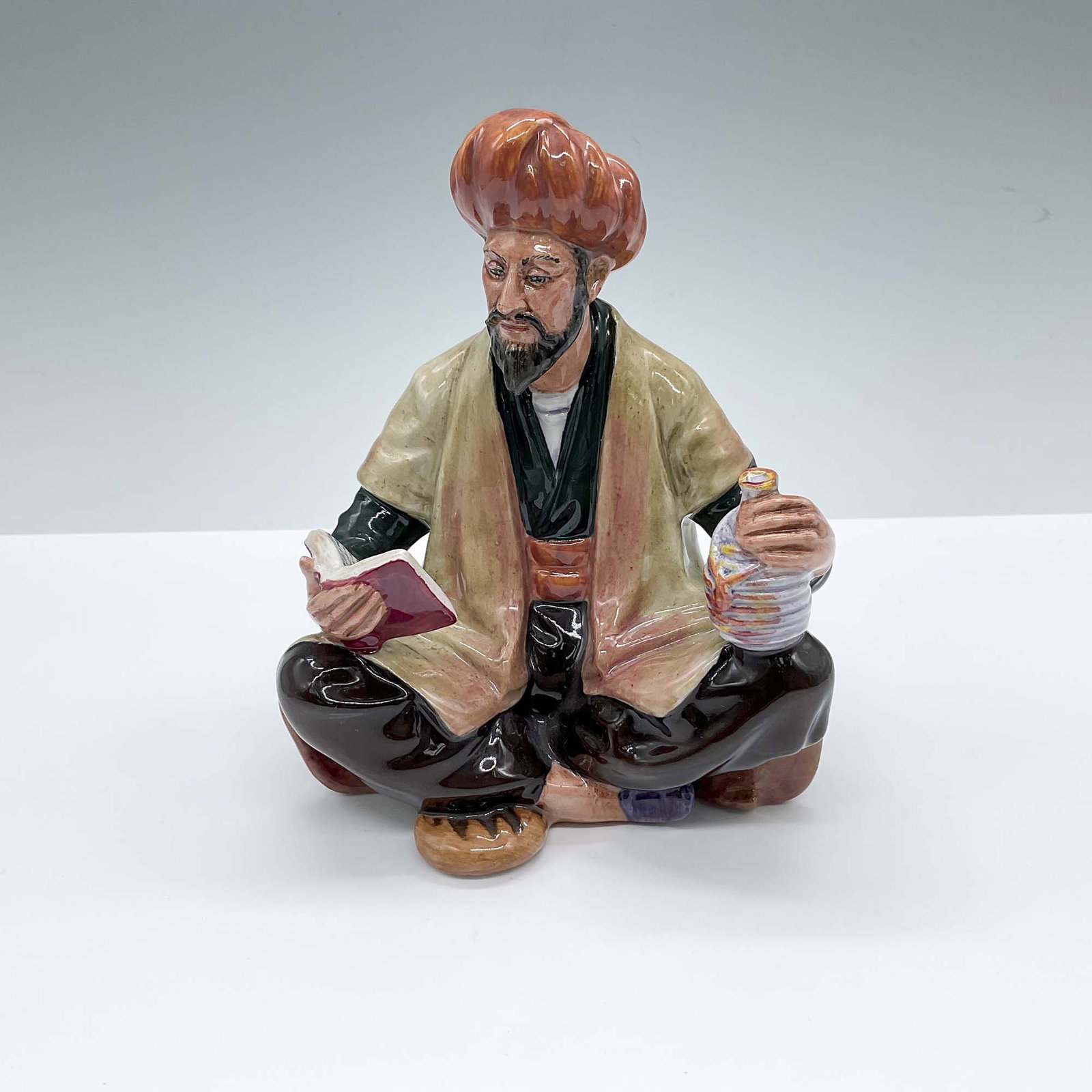 Royal Doulton Porcelain Figurine, Omar Khayyam HN2247: Hand decorated figure of the Persian polymath, who was most known for the cubic equations. Royal Doulton backstamp. Artist: M. Nicoll Dimensions: 5"L x 3.75"W x 6.25"H Issued: 1965-1983 Country of Ori