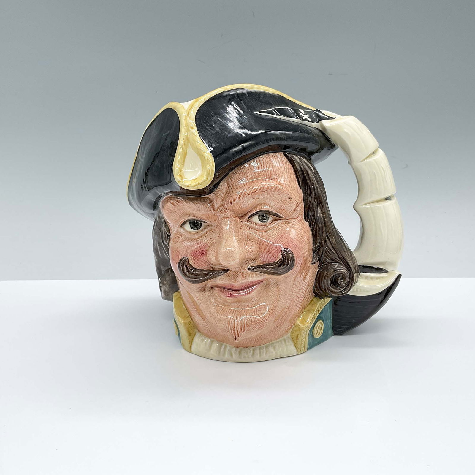 Royal Doulton Large Character Jug, Capt Henry Morgan D6467: Hand decorated and hand painted figural jug of a Welsh privateer. The handle is shaped as a shop with large sails. Royal Doulton backstamp. Artist: Garry Sharpe Dimensions: 8.5"L x 6"W x 7"H Issued: 1