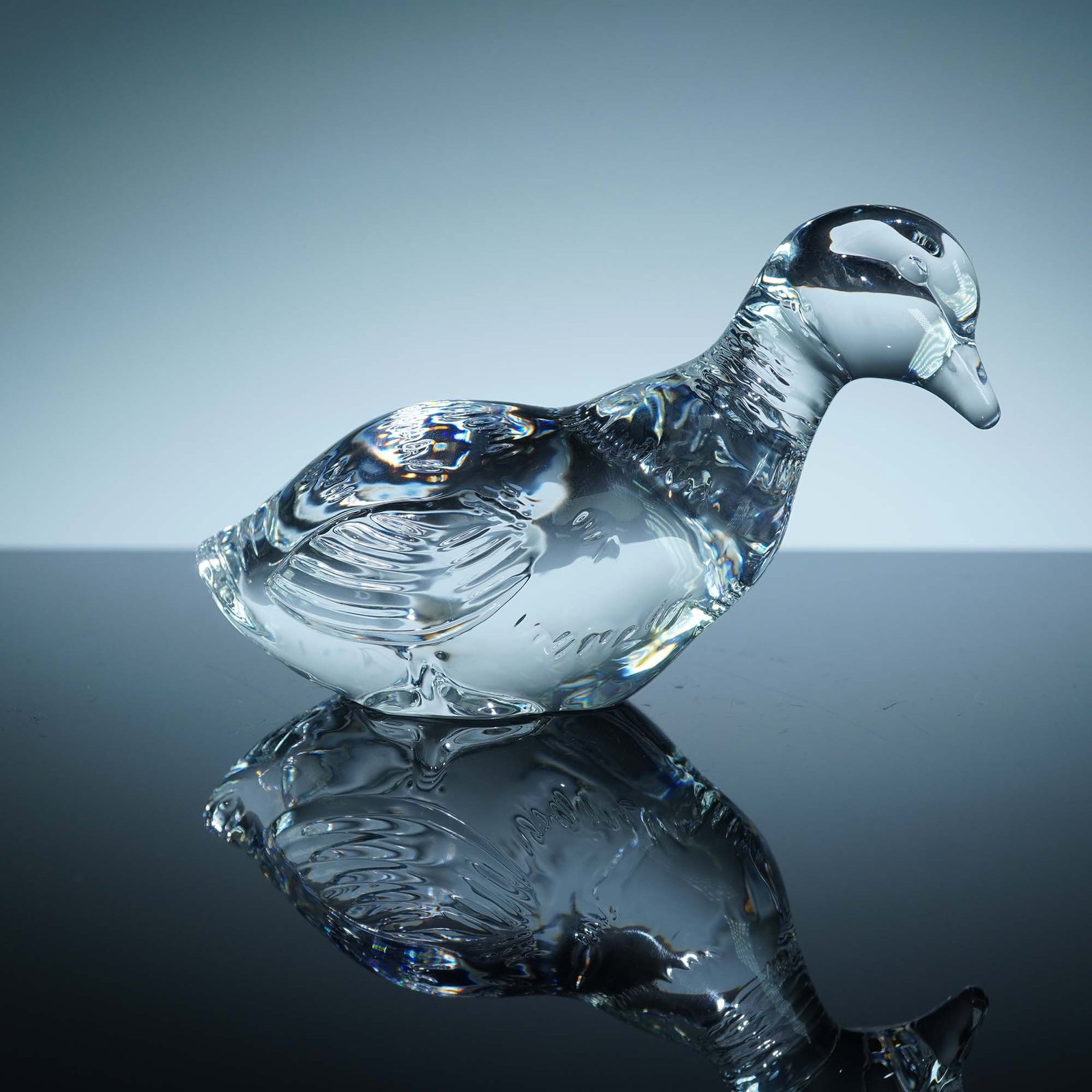 Baccarat Crystal Duck Figurine: Finely crafted clear crystal duck figurine by Baccarat, showcasing the brand's signature precision and clarity. This sculpted piece features detailed wings, tail, and facial contours, highlighting the