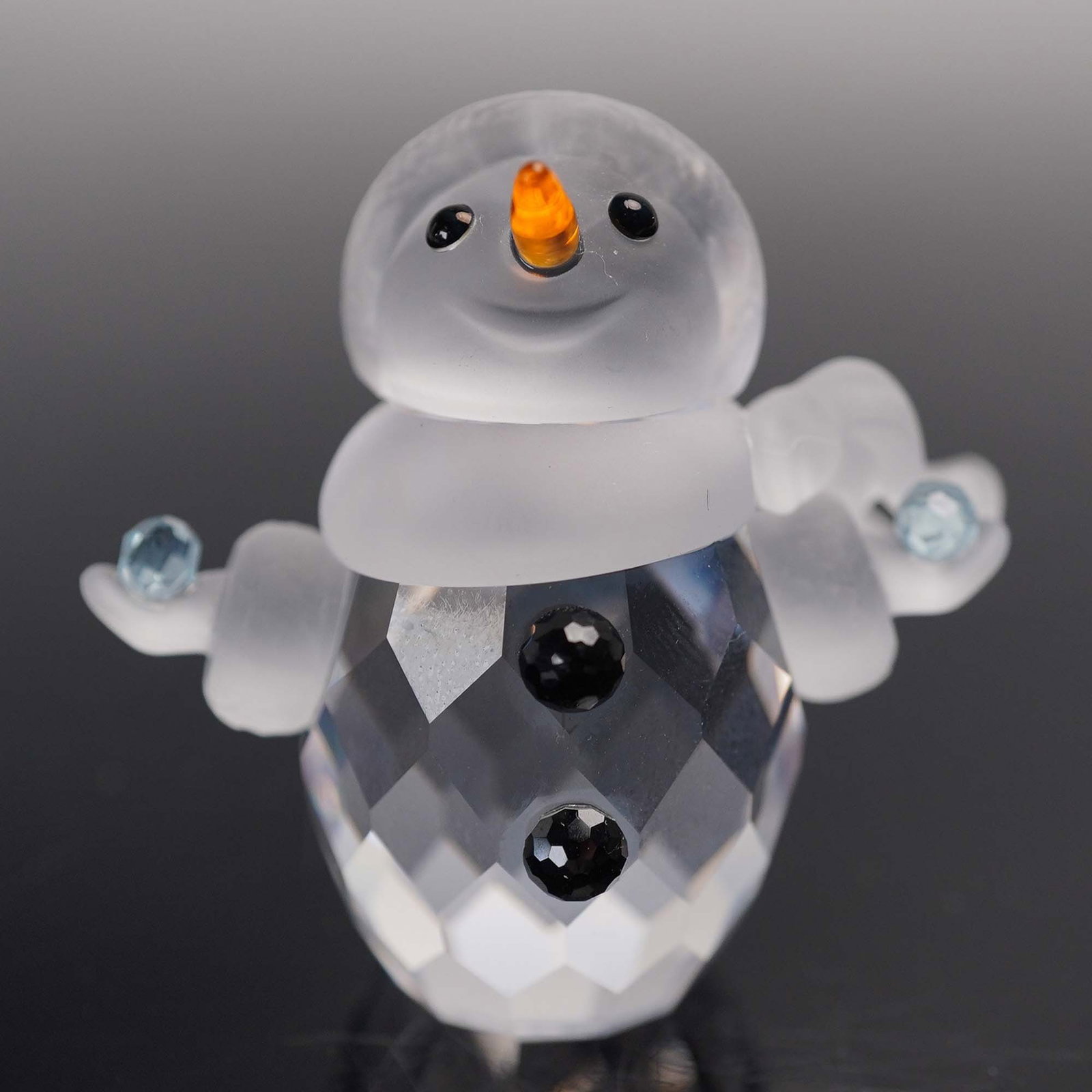 Swarovski Crystal Figurine, Little Snowman: This retired Swarovski crystal figurine, belongs to the, Cheerful Times, theme and was originally part of the, When We Were Young, collection. The snowman features a faceted clear crystal body with a 