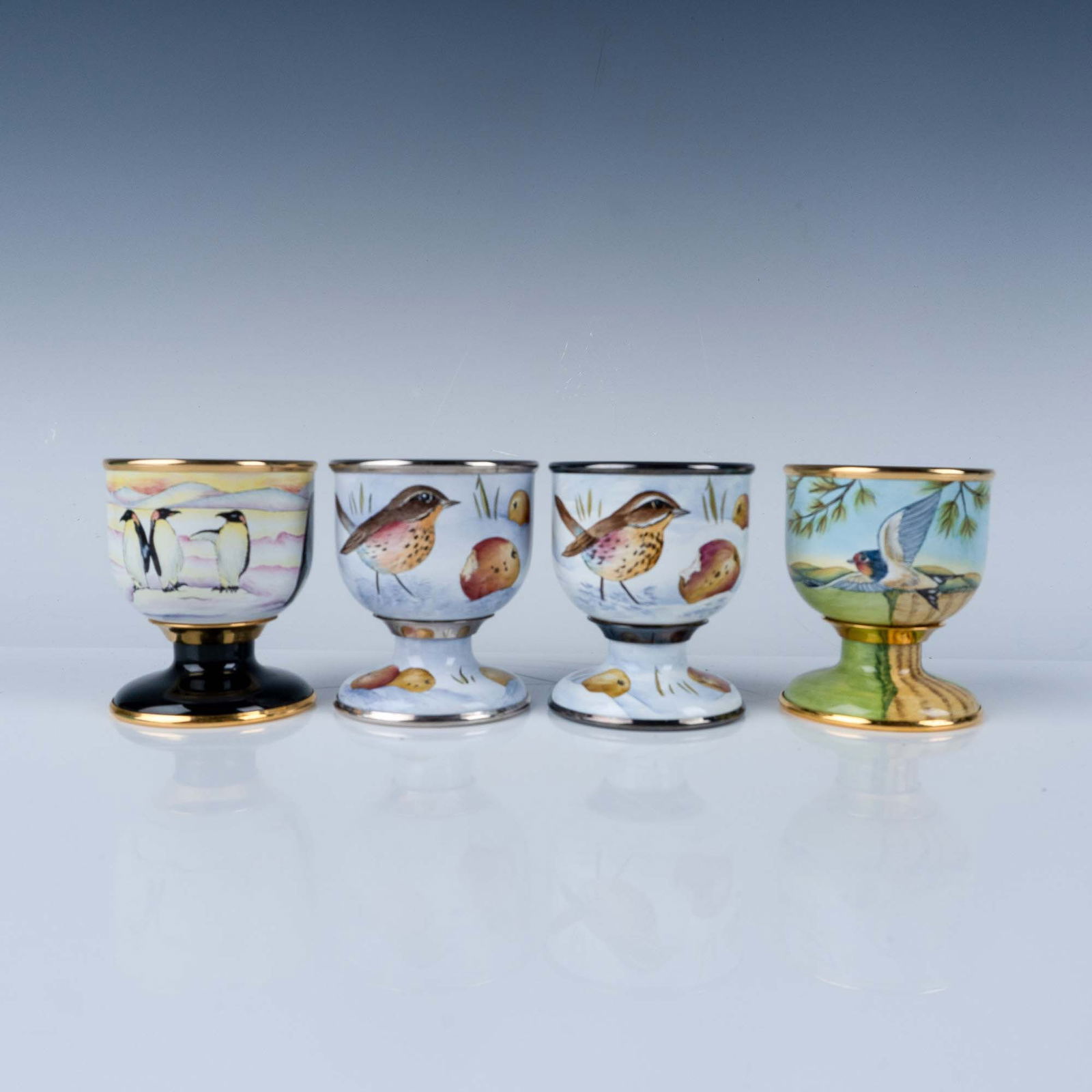 4pc Moorcroft Enamel Bird Egg Cups: This exquisite set of 4 Moorcroft enamel egg cups is a testament to the brand's enduring craftsmanship and artistry. Each cup is meticulously hand-painted with vibrant depictions of birds and wildlife
