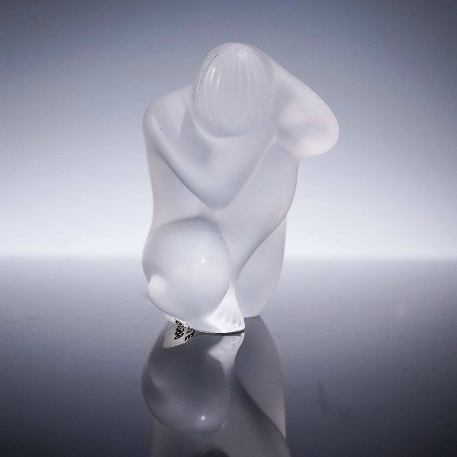 Lalique Frosted Crystal Figurine, Nude with Hand on Head, 1996: Lalique frosted crystal figurine titled Nude with Hand on Head, created exclusively for the Lalique Collectors Society in 1996. This sculptural form depicts a nude female figure posed in a seated posi