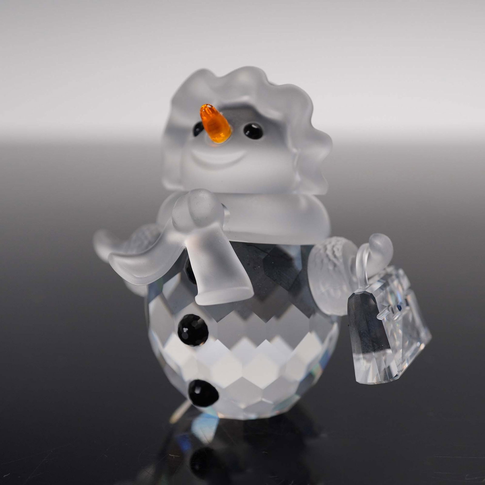 Swarovski Crystal Figurine, Snow Woman with Purse: This retired Swarovski crystal snow woman was part of the, Cheerful Times theme, and originally a member of the, When we were young collection. She has a clear crystal body, frosted face, scarf and ha