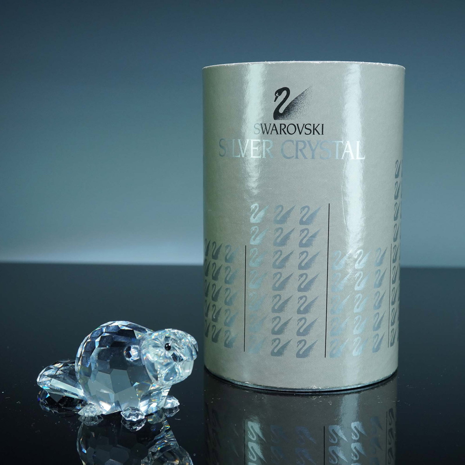 Swarovski Crystal Figurine, Beaver Mother: Figurine depicting a beaver mother, part of the "Endangered Species" collection. The figure is crafted from clear faceted crystal, featuring molded feet, a broad flat tail, and upright ears. The beave