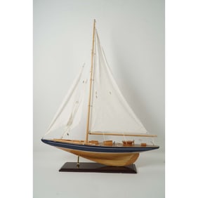 Handcrafted Wooden Model Sailboat with White Sails on Display Stand