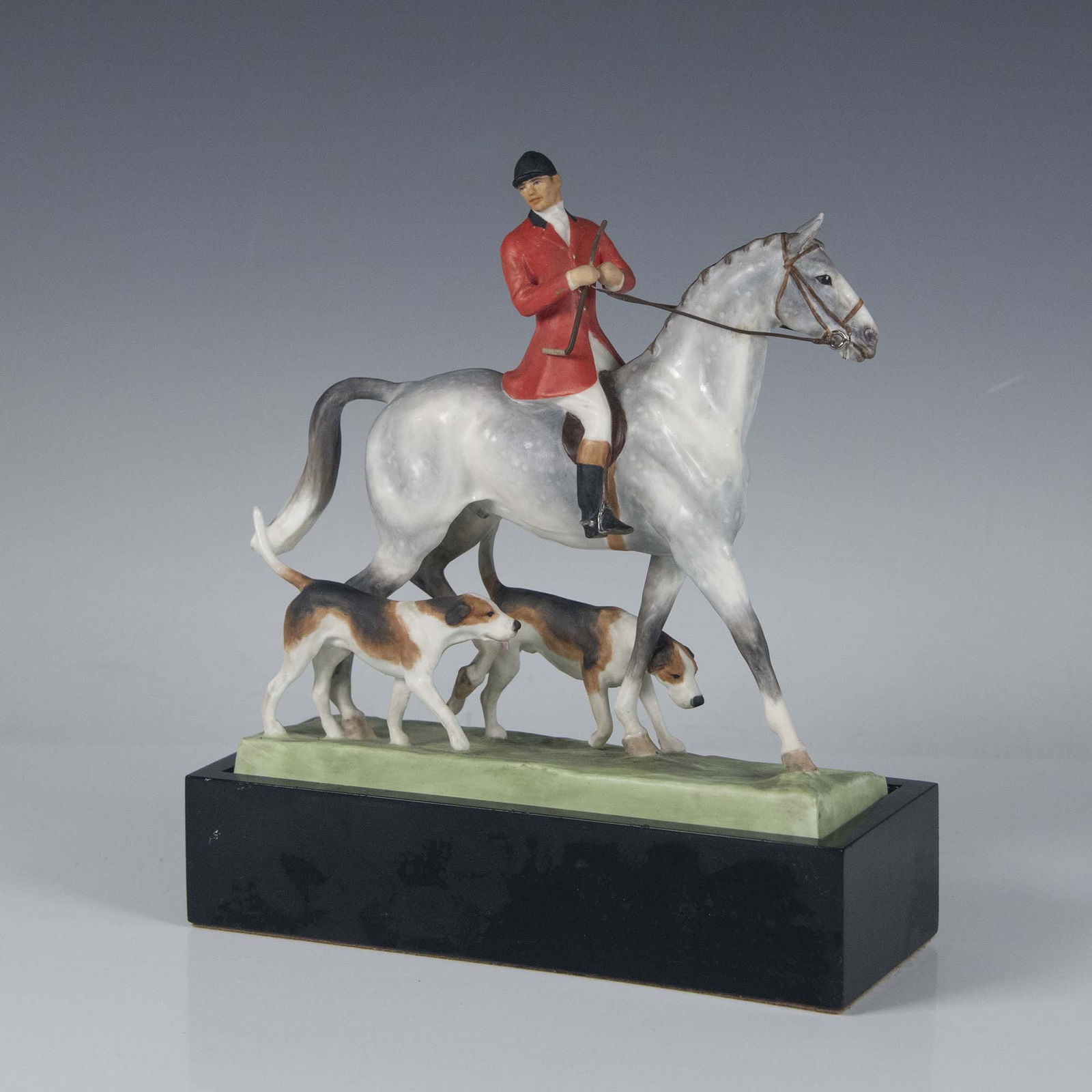 Royal Worcester Bone China Figurine, Huntsman & Hounds: Modeled by Doris Lindner. Hand painted figure of a huntsman on a horse, two loyal hounds by his side. Royal Worcester backstamp. This item has a base included, approximately measures: 8.25"L x 3.25"W