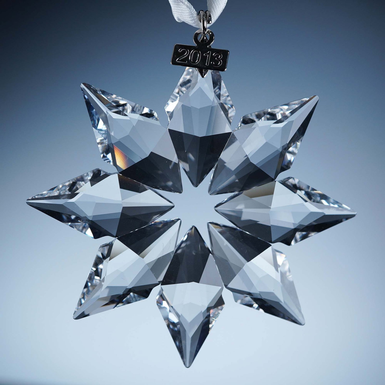 Swarovski Crystal Ornament, 2013 Christmas: This retired Swarovski 2013 Annual Edition Christmas Ornament features a striking star design with eight intricately faceted crystal points radiating in symmetrical brilliance. Crafted in clear crysta