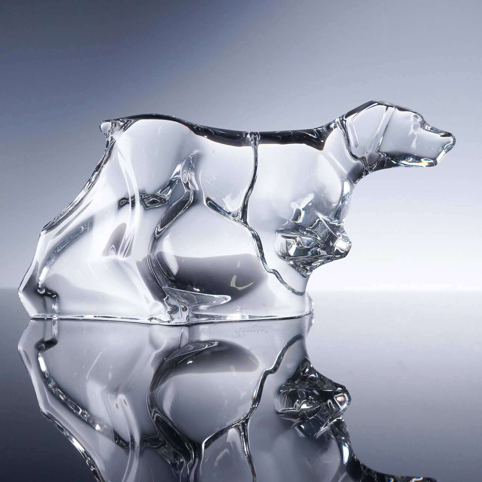 Baccarat Crystal Figurine, Pointer Dog: This finely sculpted Baccarat crystal figurine features a graceful pointer dog captured in motion with a raised front paw and extended neck, true to the breed's classic pointing stance. Crafted in lum