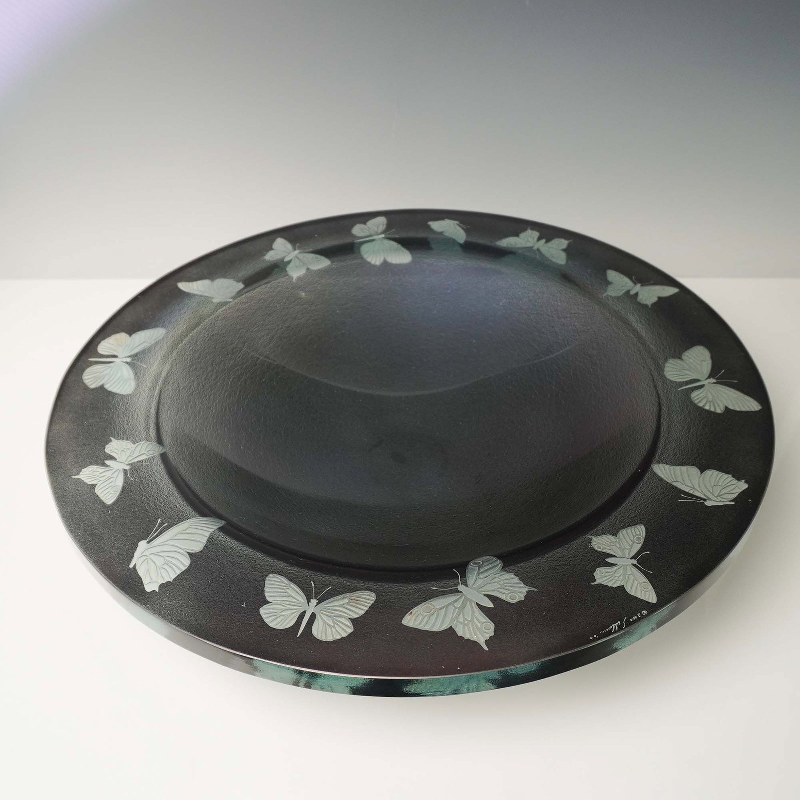 Stephen Schlanser Art Glass Centerpiece Bowl, Butterfly: This exceptional fused glass centerpiece bowl by noted American glass artist Stephen Schlanser features a dramatic matte black finish with a wide rim and deep central well. Encircling the outer edge a