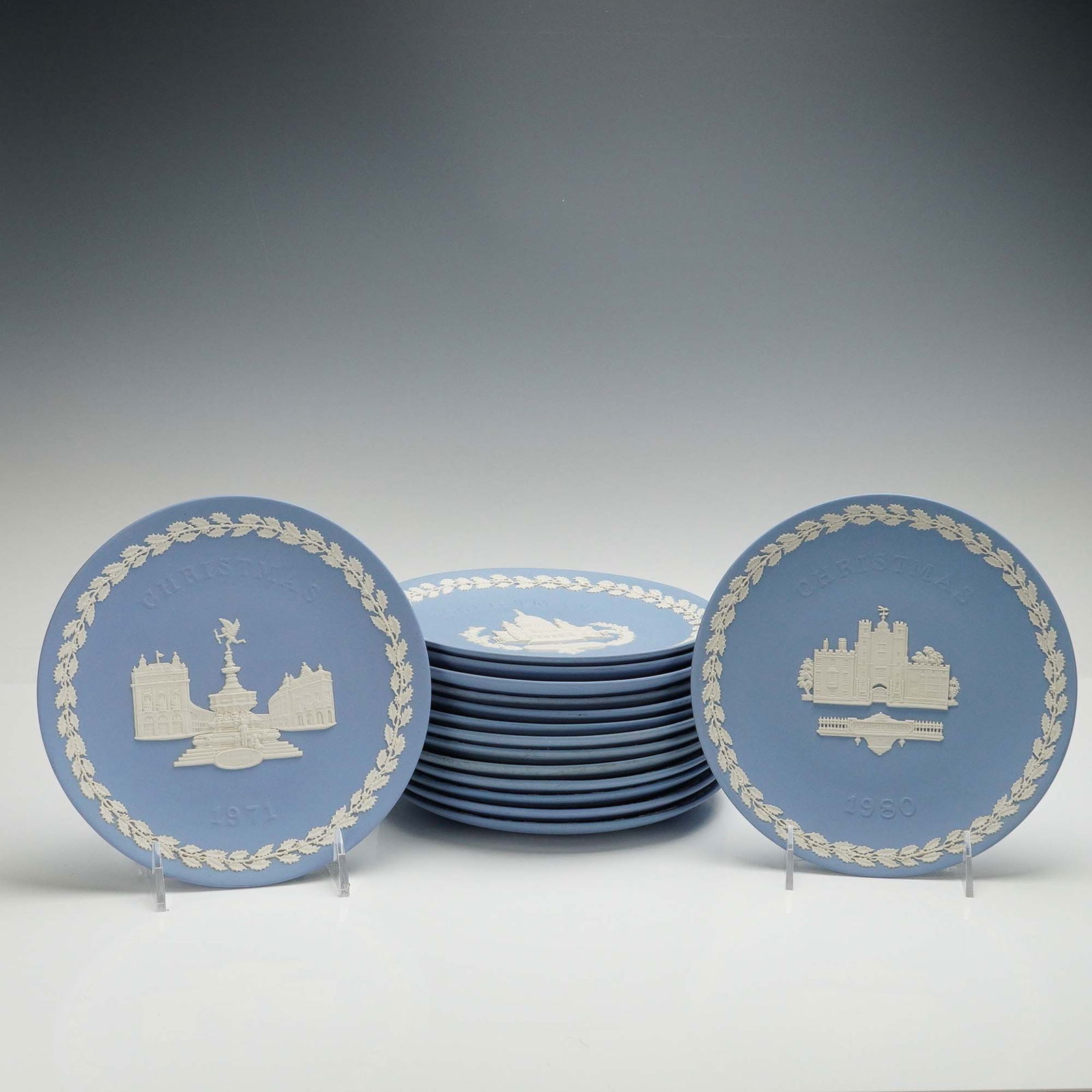 15pc Wedgwood Jasperware Christmas Plates: Extensive collection of fifteen Wedgwood Jasperware Christmas plates, crafted in the iconic pale blue with white bas-relief decoration. Each plate features a unique scene from notable British architec
