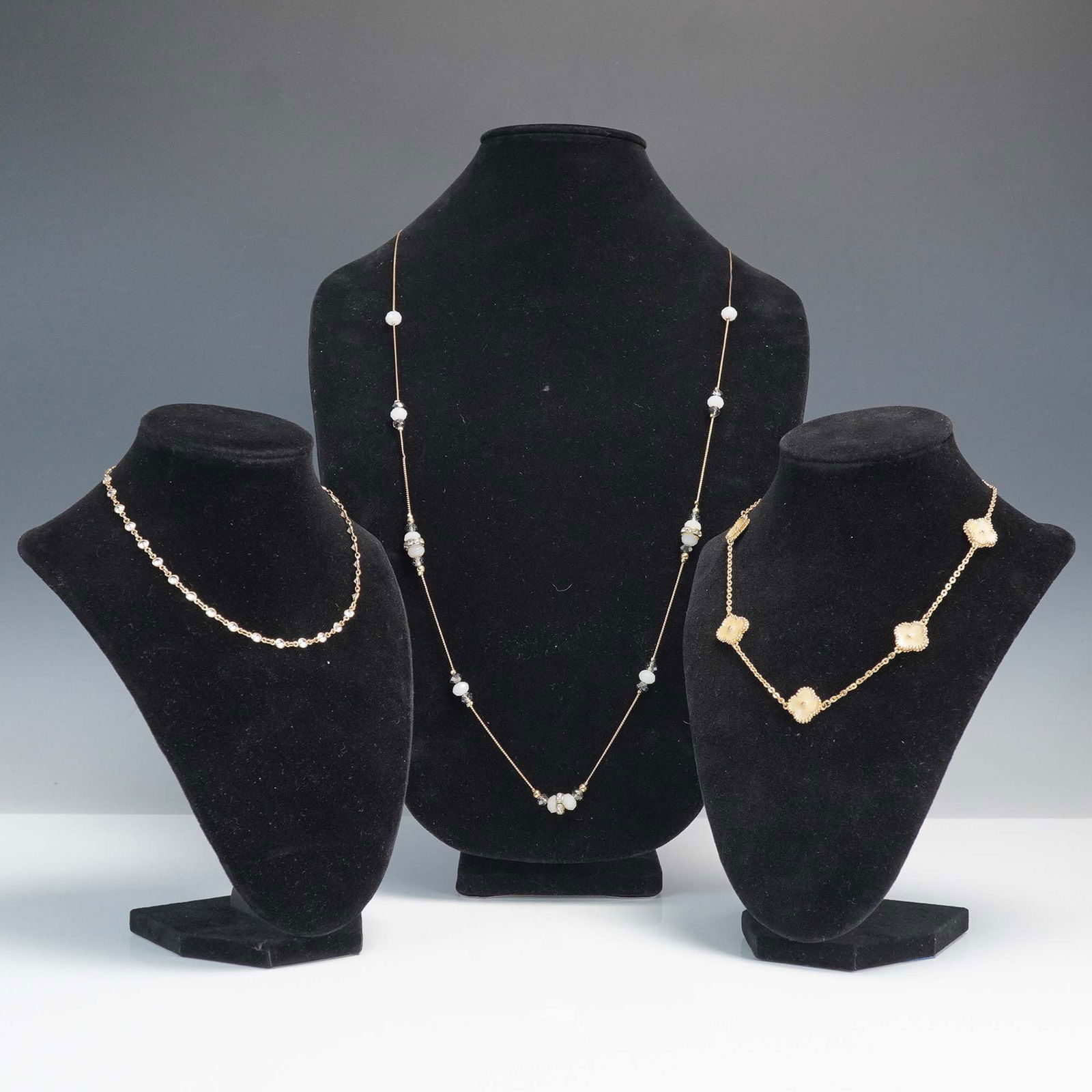 3pc Gold-Tone Beaded and Crystal Accent Necklaces.: Collection includes a faceted beaded necklace with gold-tone findings and white and black beads separated by a ring of small clear rhinestones. Also includes a necklace with clover-shaped floral segme