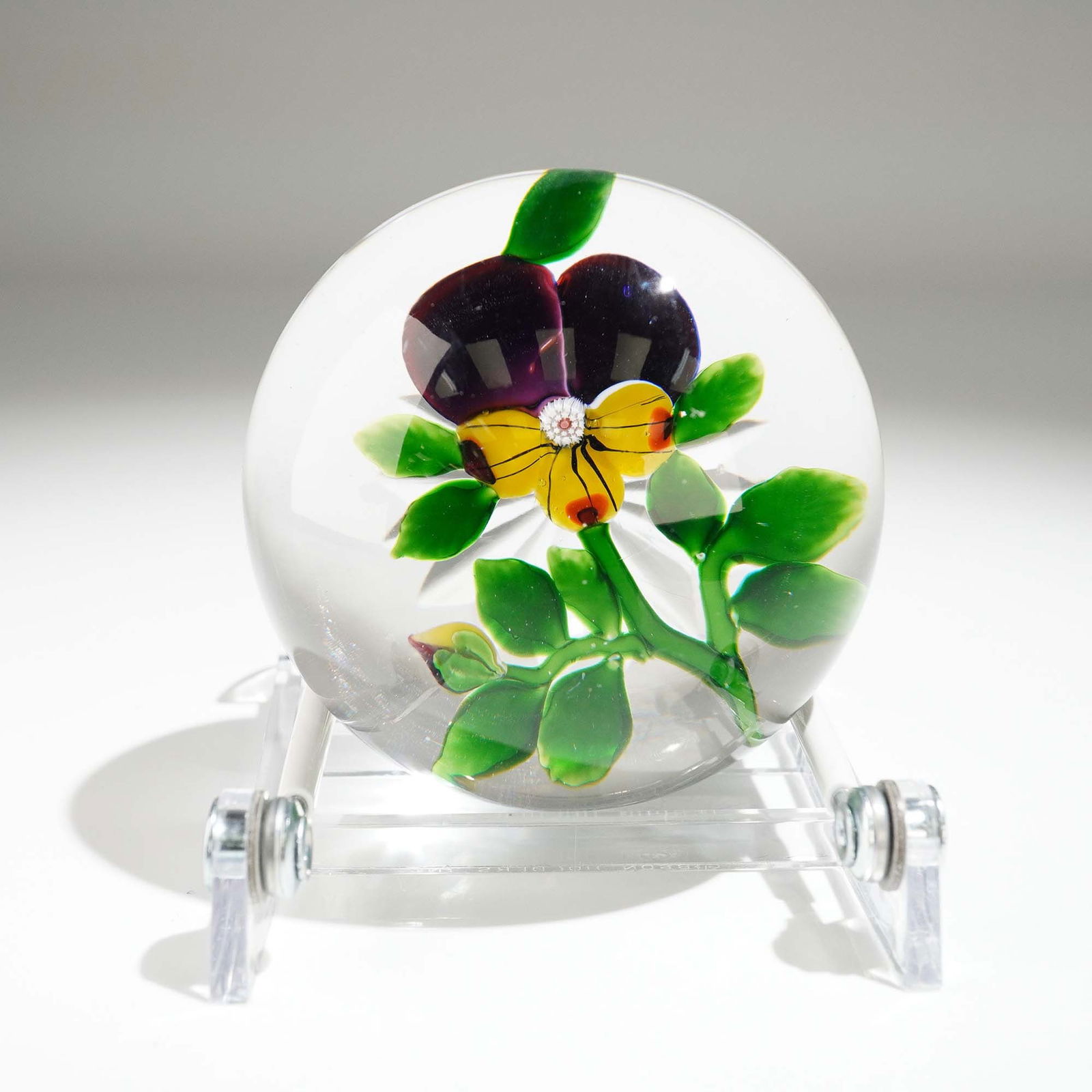Antique Baccarat Art Glass Paperweight, Pansy Flower: This exquisite Baccarat crystal paperweight features a beautifully detailed pansy blossom in rich yellow and deep plum purple tones, suspended within a clear glass dome. Originating from France and fi