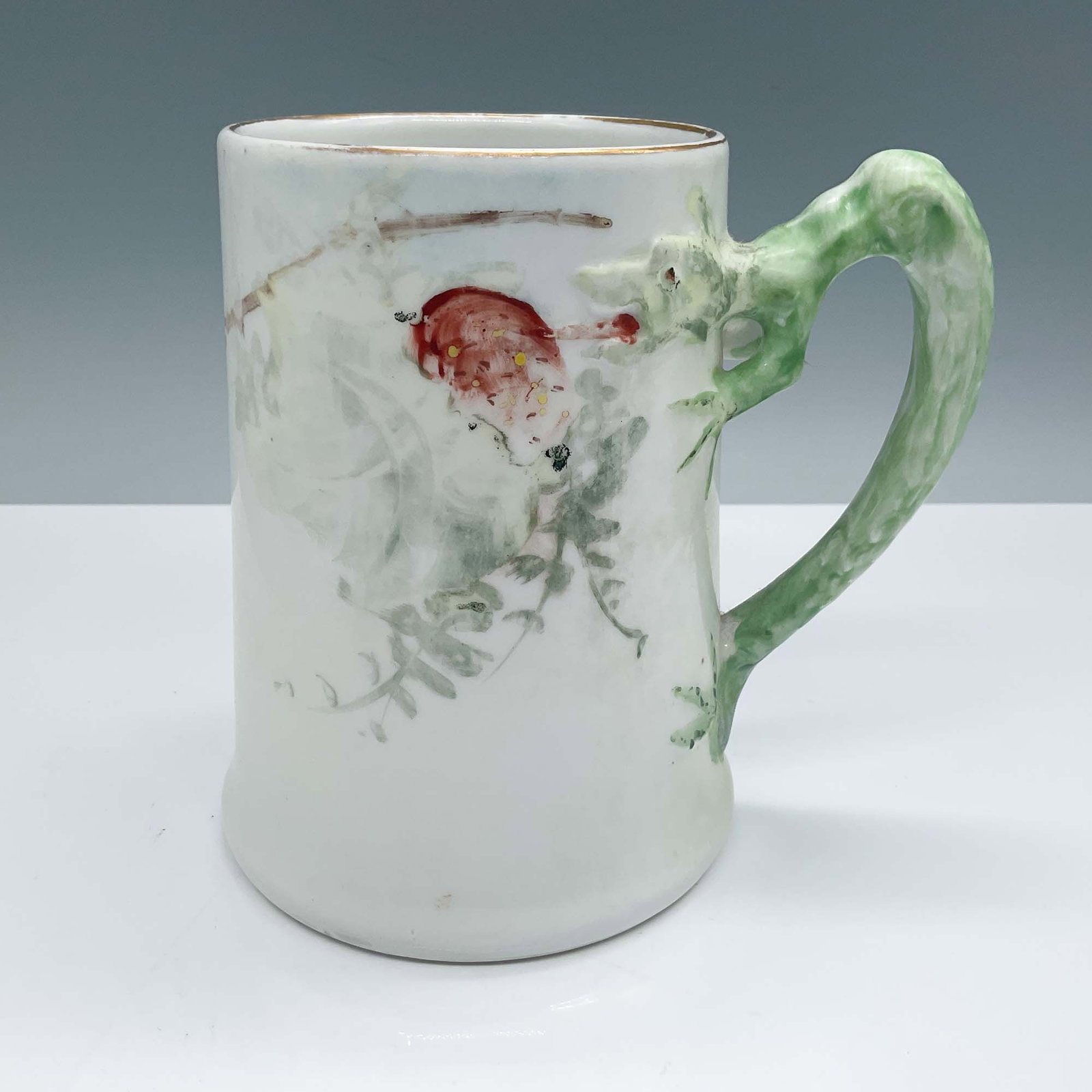 Heinrich & Co. Selb Bavaria Mug, Strawberries and Flowers: Hand-painted Heinrich & Co. Selb Bavaria ceramic mug featuring a delightful strawberries and flowers motif, complemented by a textured green handle designed to resemble foliage. The underside bears th